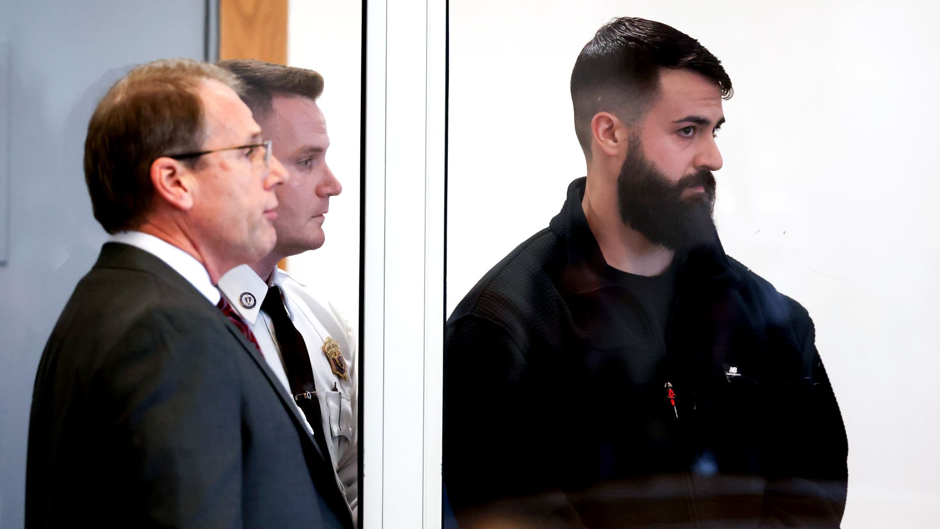 Boston police officer Nicholas O’Malley stands in court during his arraignment on a manslaughter charge related to a fatal shooting.