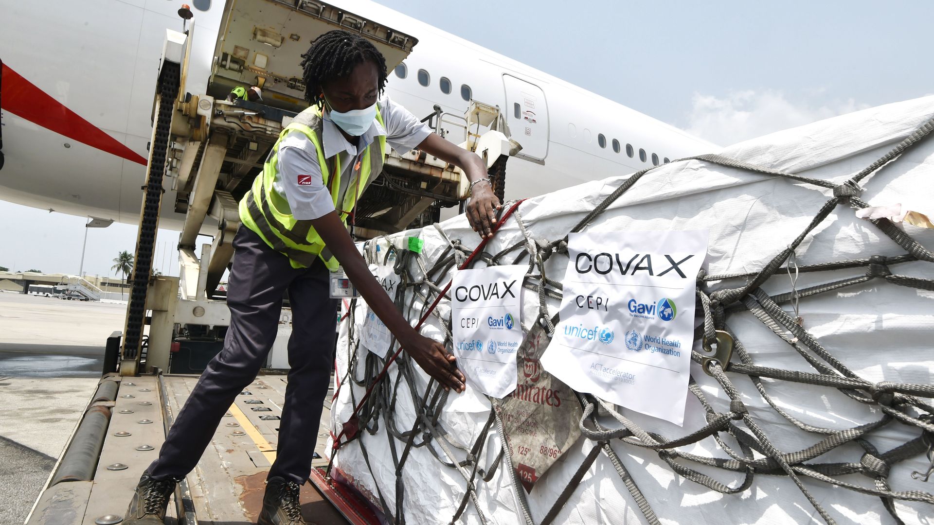 A person unloading a shipment of AstraZeneca Covid-19 vaccine from a plane in Abidjan, Côte d'Ivoire, in February 2021.