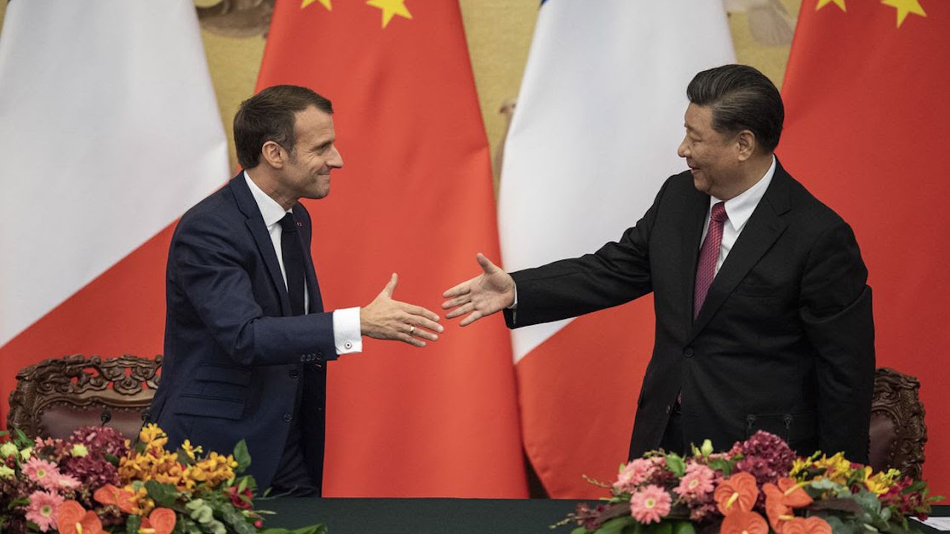 French President Macron shakes hands with Chinese President Xi