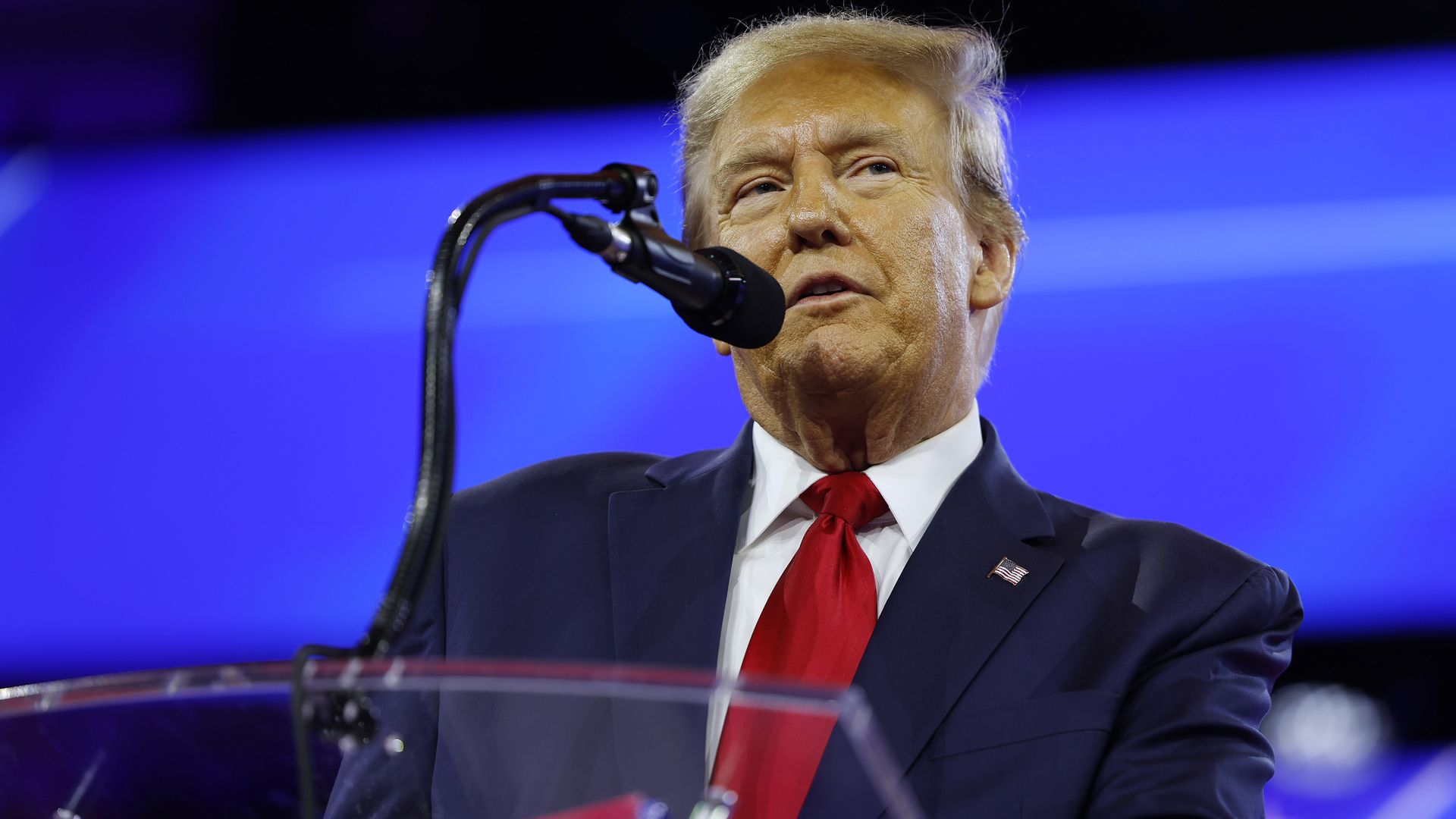 Former President Trump speaks into microphone