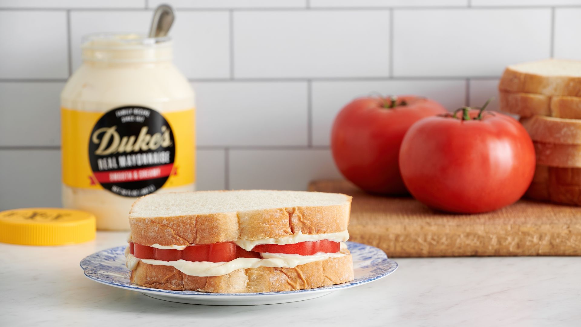 A jar of Duke's mayo with tomatoes  