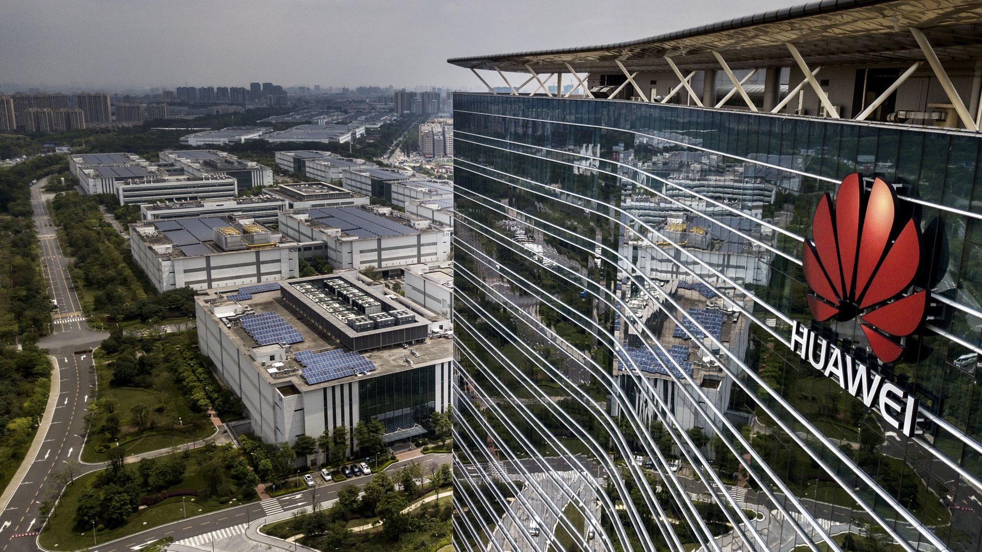 This image shows a birds eye view of the Huawei logo on a skyscraper.