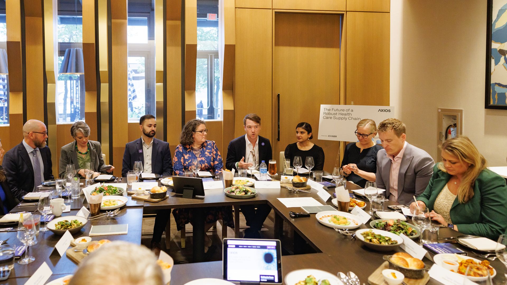 Attendees sit around the table during the discussion.