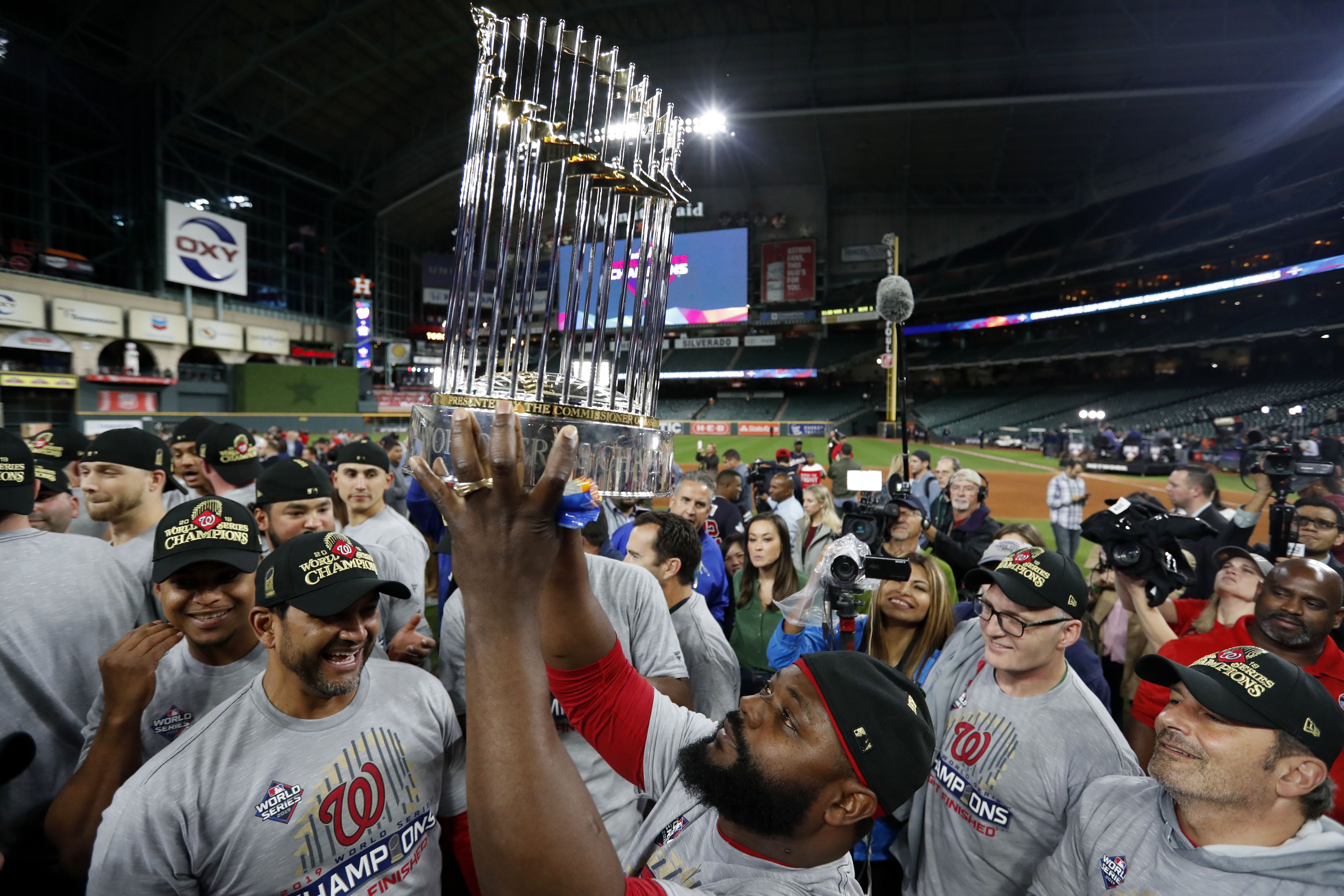 Fernando Rodney #56 of the Washington Nationals hoists the Commissioner's Trophy after the Nationals defeated the Houston Astros in Game 7