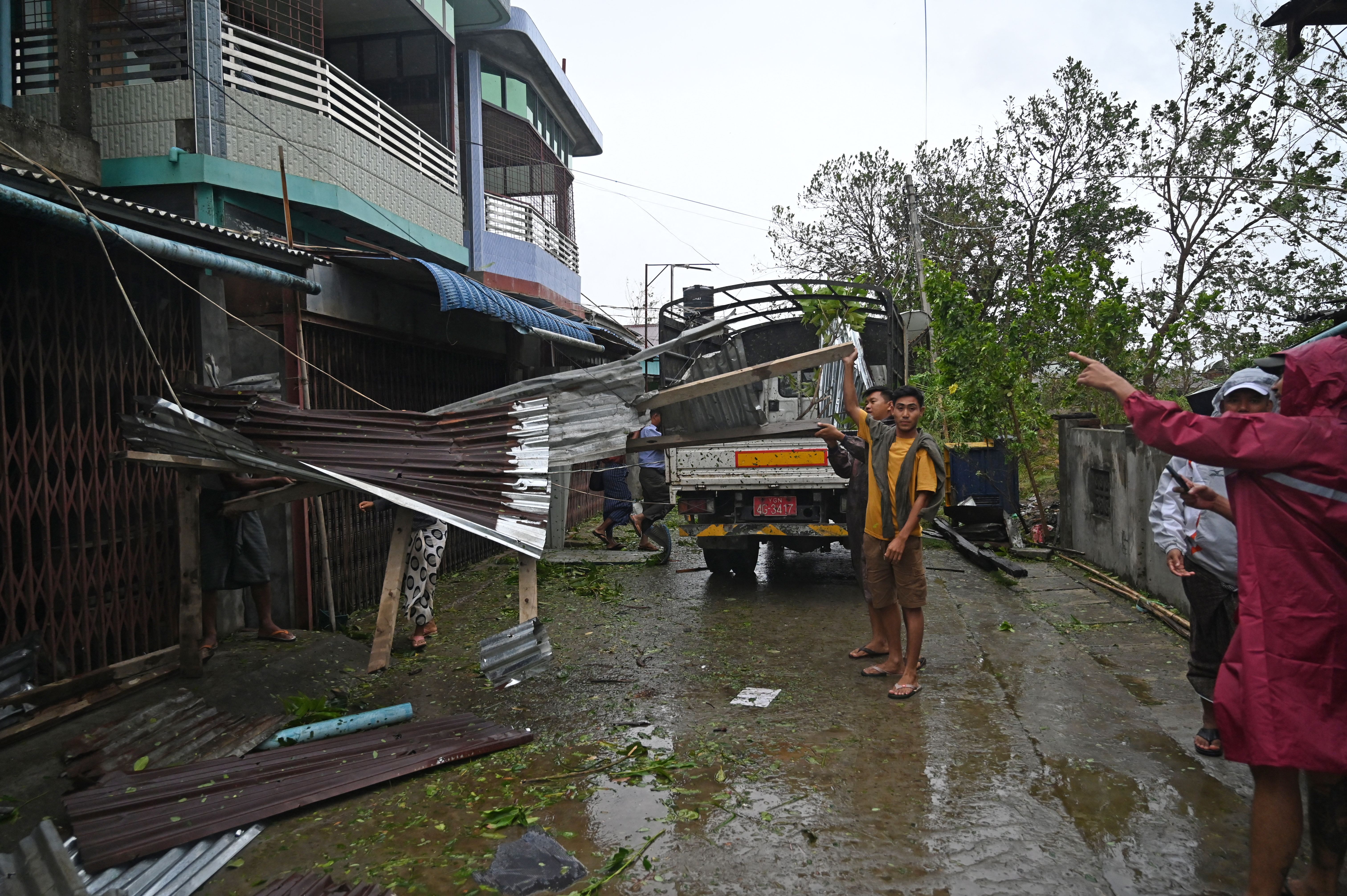 Local residents check the damages after Cyclone Mocha's crashed ashore, in Kyauktaw in Myanmar's Rakhine state on May 14