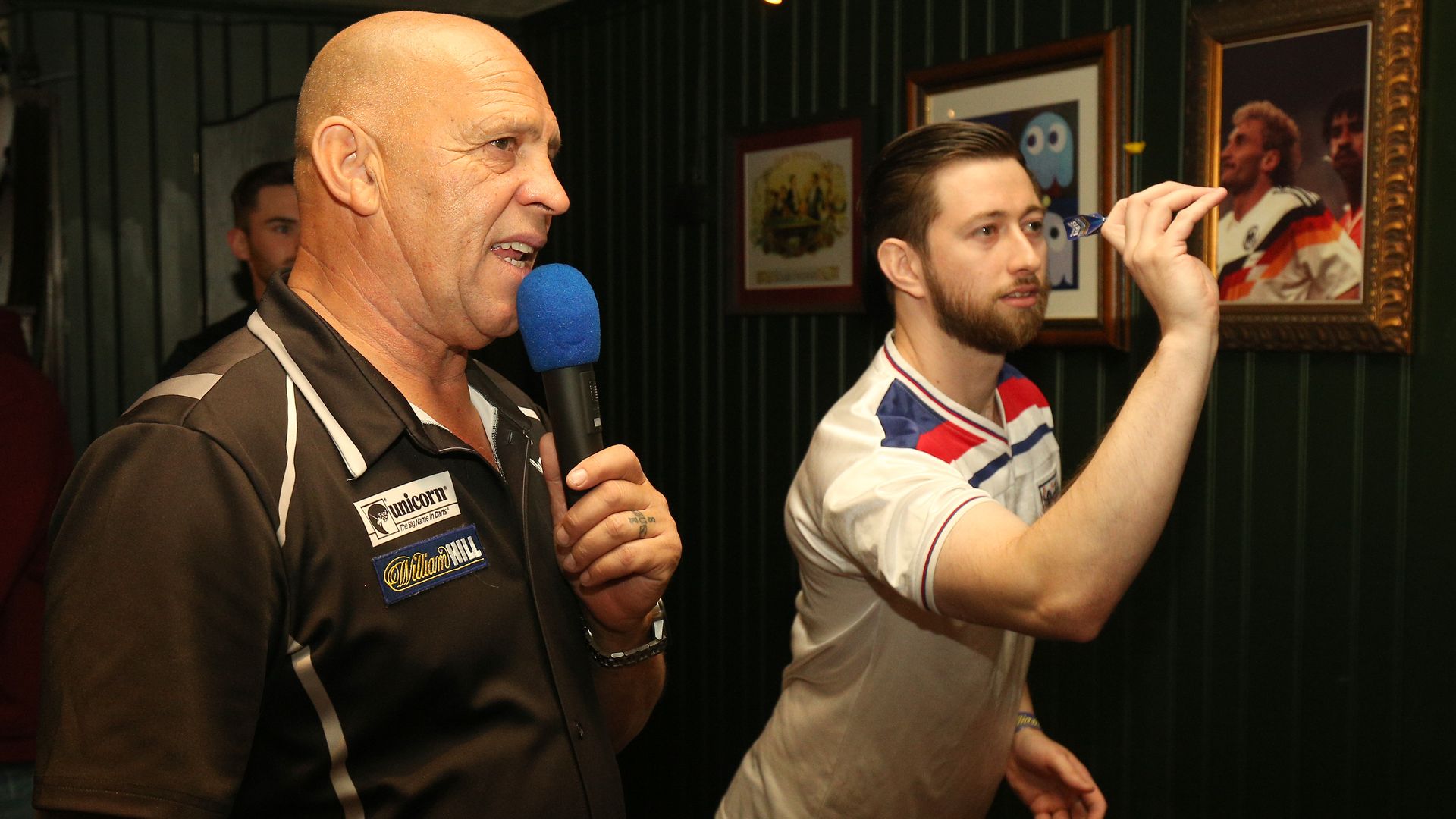 A darts referee and player