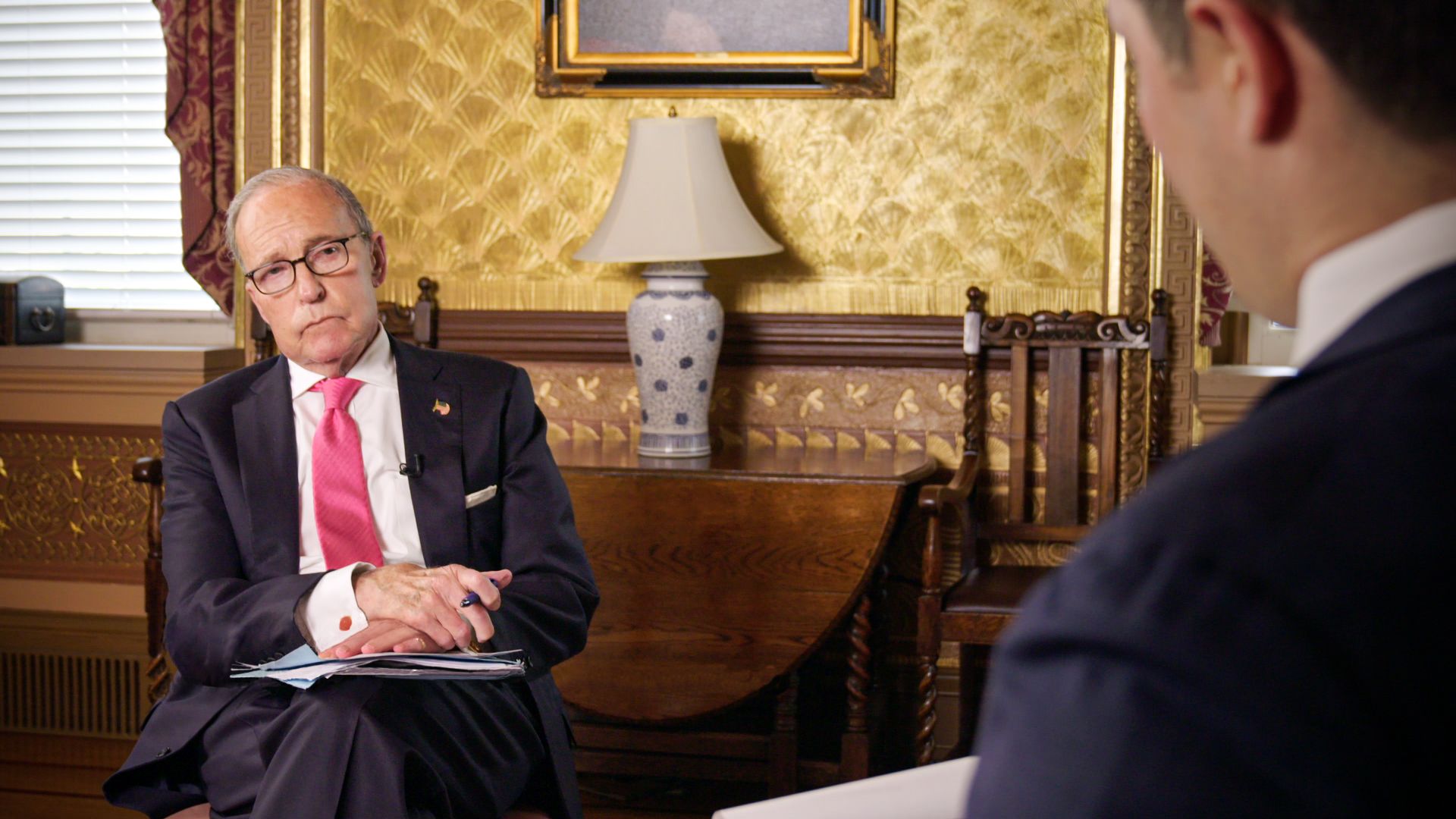 Larry Kudlow leans back while being interviewed by Jonathan Swan of Axios
