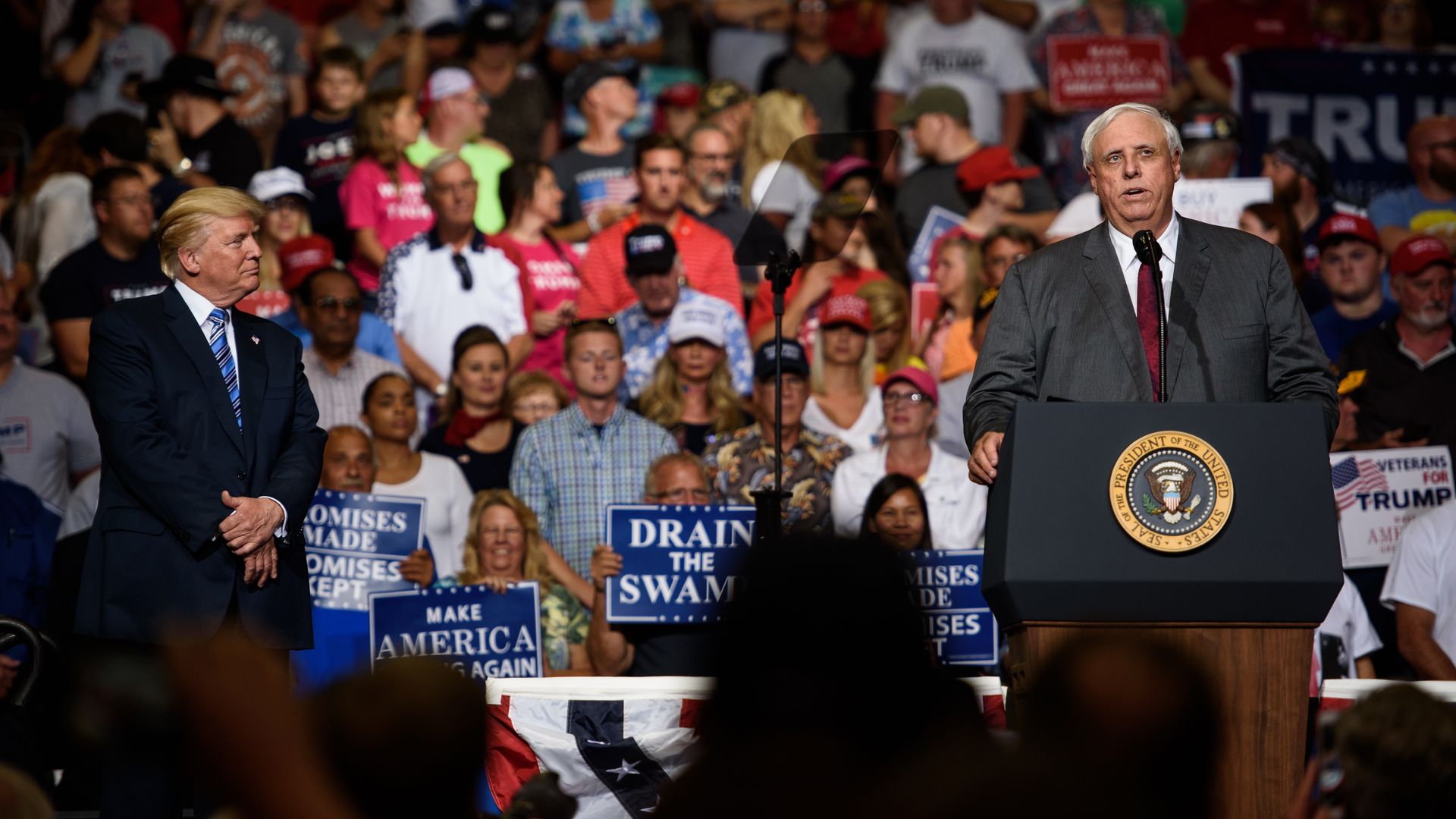 West Virginia Governor Jim Justice announces that he is switching parties to become a republican as President Donald J. Trump listens on at a campaign rally at the Big Sandy Superstore Arena on August 3, 2017 in Huntington, West Virginia.