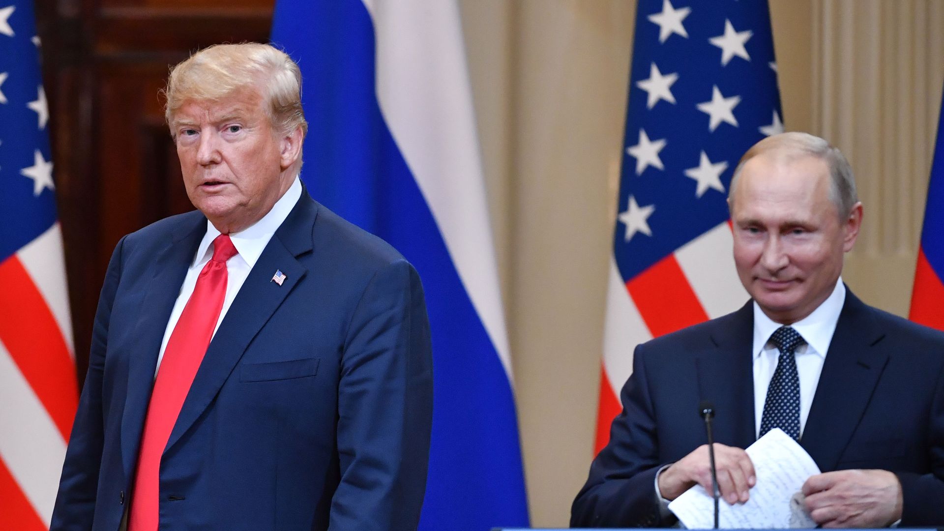 US President Donald Trump (L) and Russia's President Vladimir Putin arrive to attend a joint press conference after a meeting at the Presidential Palace in Helsinki, on July 16, 2018. 