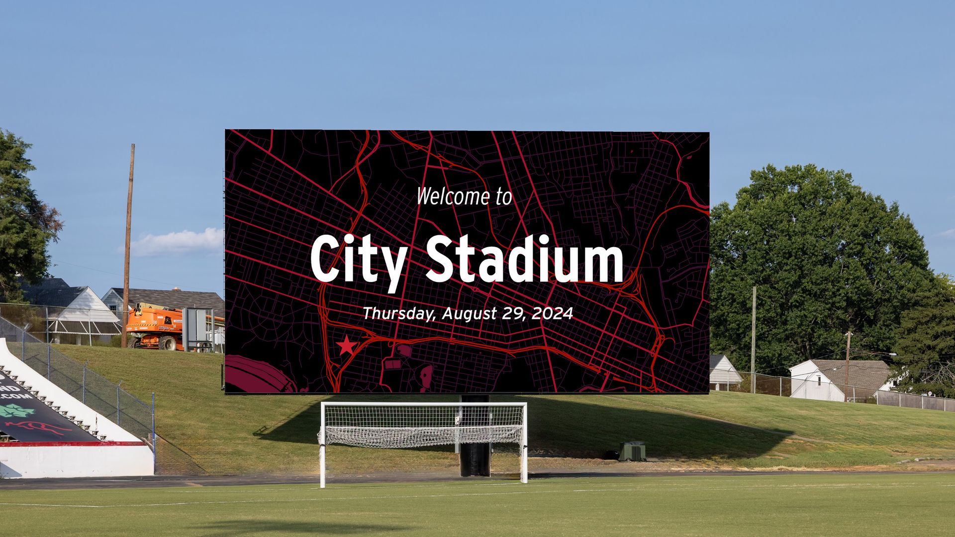 A giant scoreboard that says "Welcome to City Stadium" on a soccer field