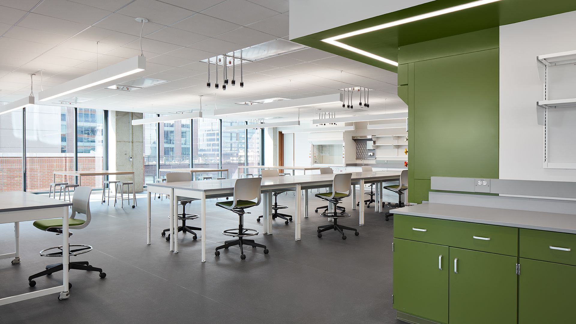 Photo of a lab with white tables and chairs. 