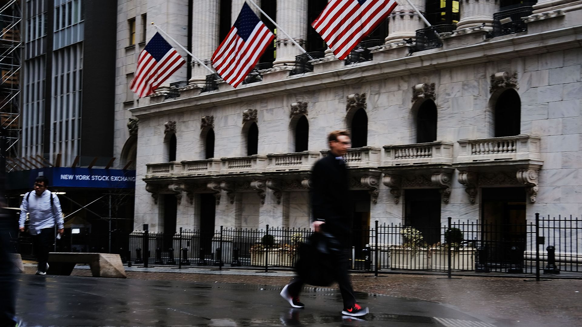 Man walks by the New York Stock Exchange.