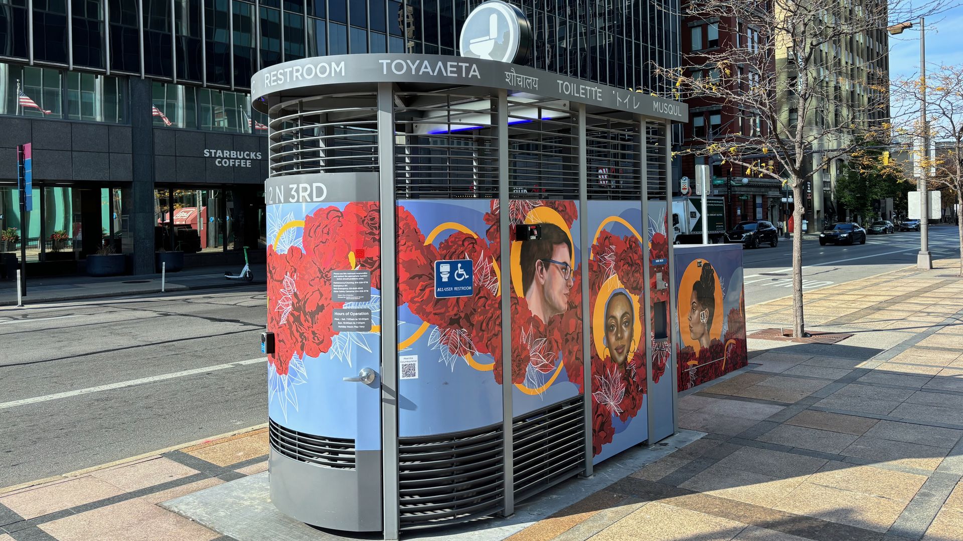 A view from Third Street of the public restroom covered with floral artwork at the corner of Third and Broad streets