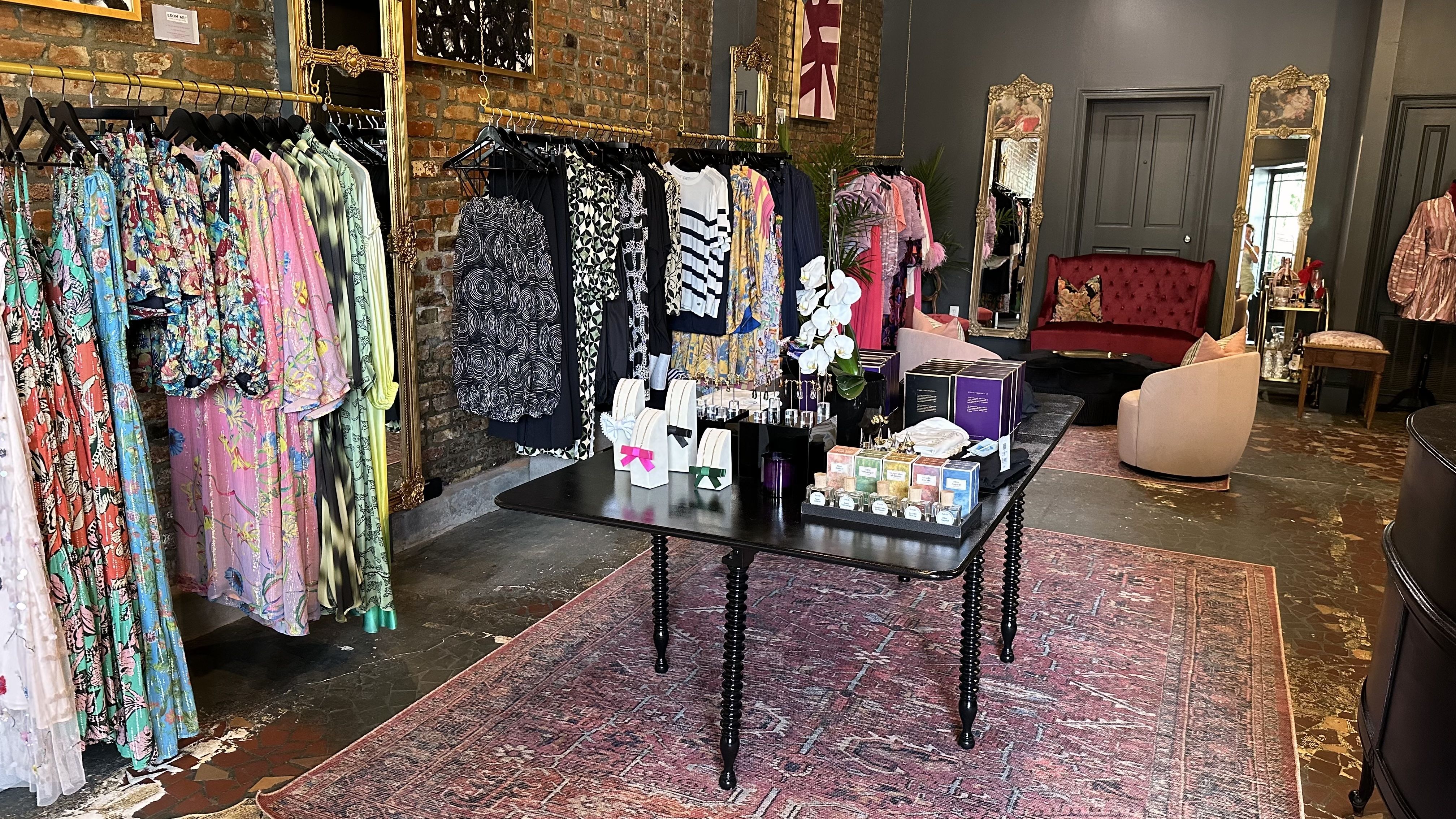 A wide view of Le Marais. Racks of clothing line the edges of the shop.
