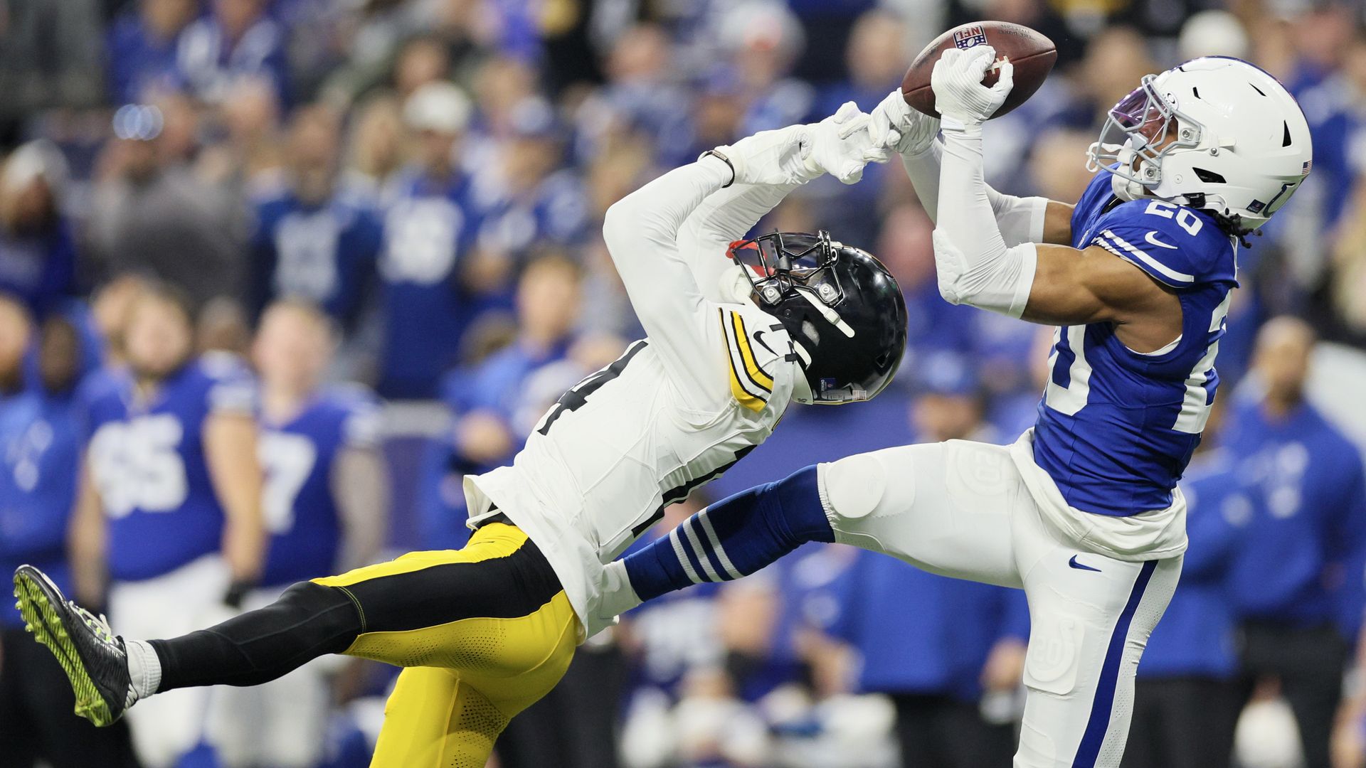 Nick Cross of the Colts intercepts a pass intended for George Pickens of the Steelers.