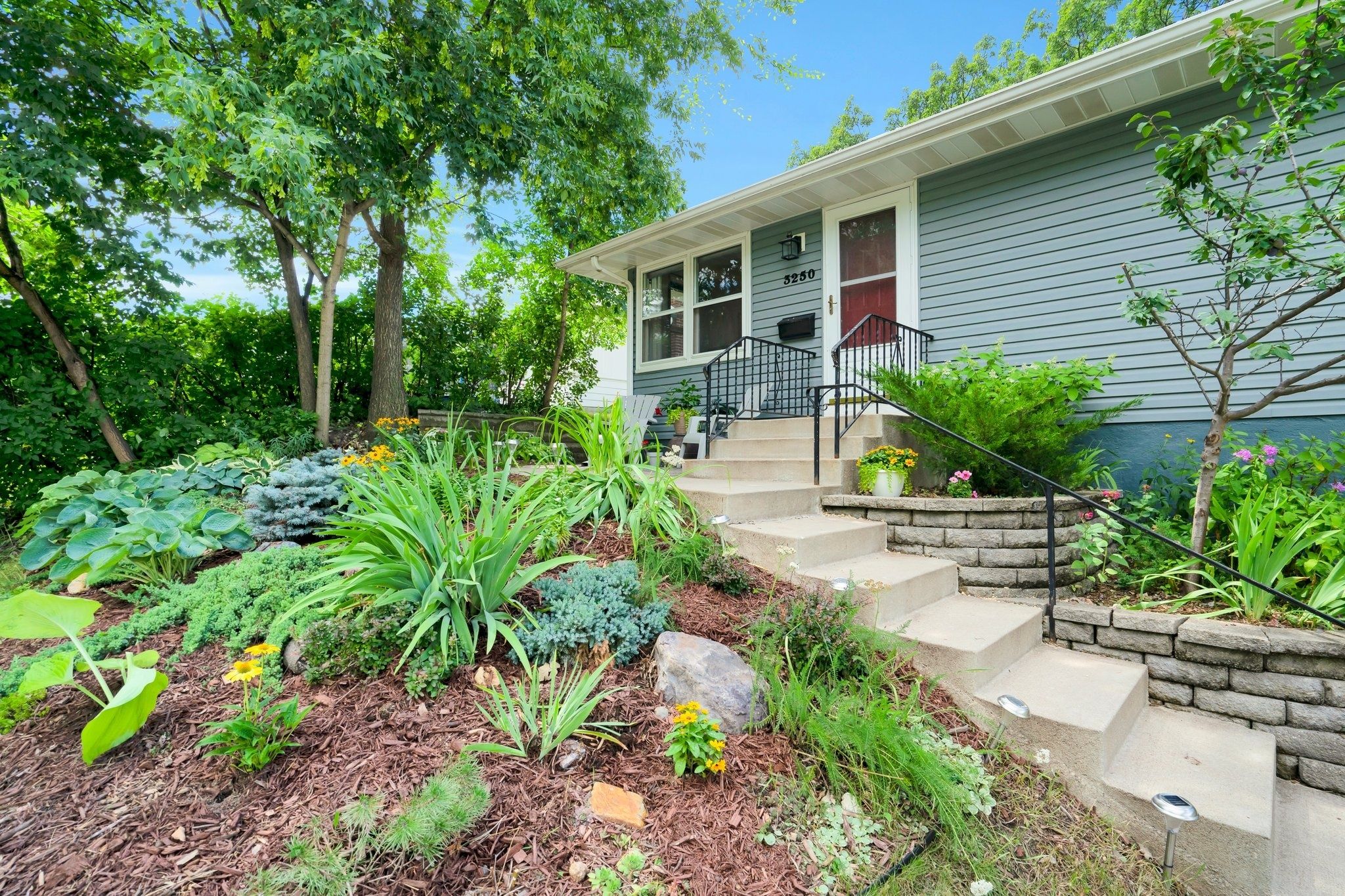 exterior of home on slope with greenery