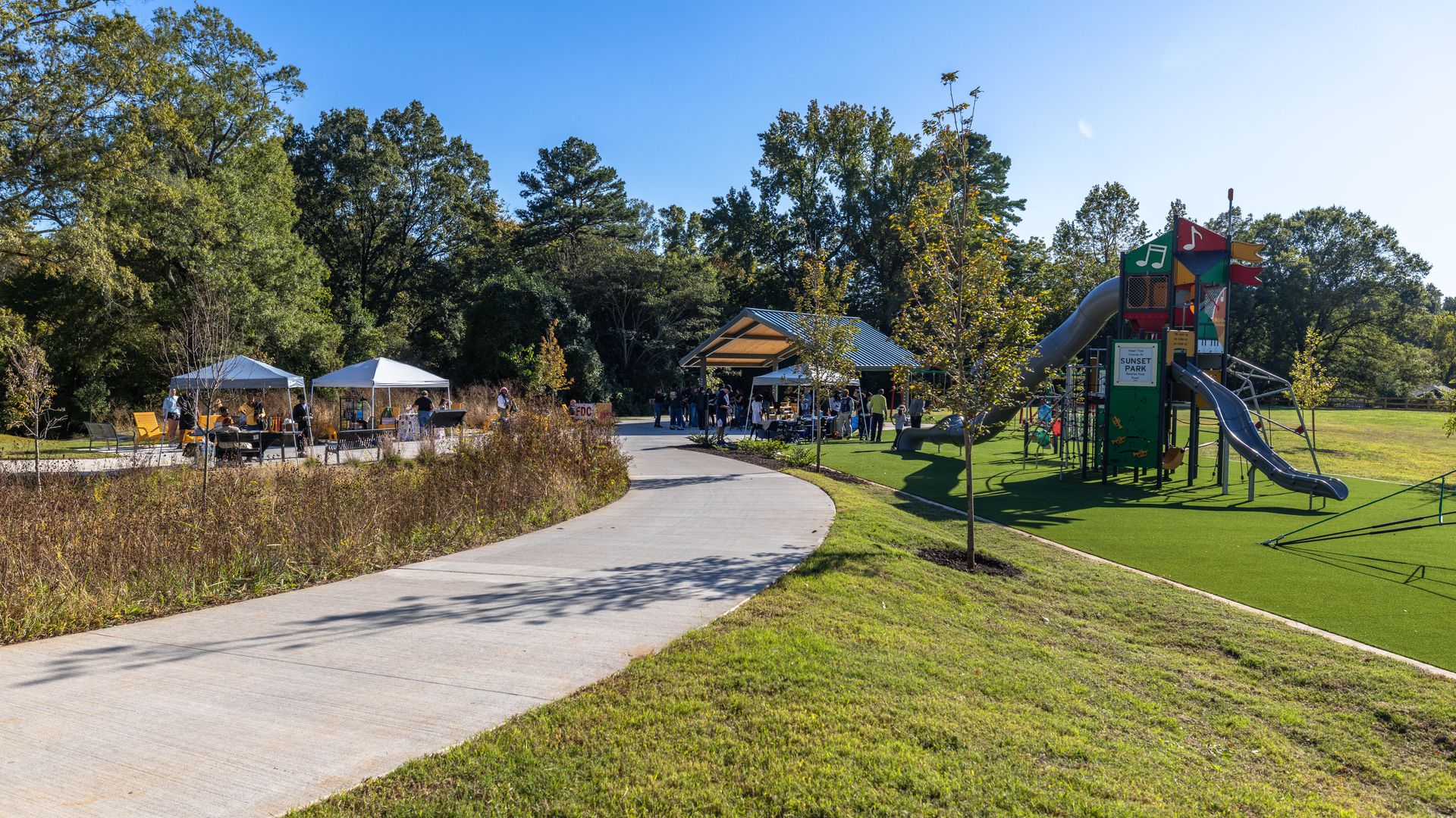 L.C. Coleman park with a playground and walking trails on a sunny day.