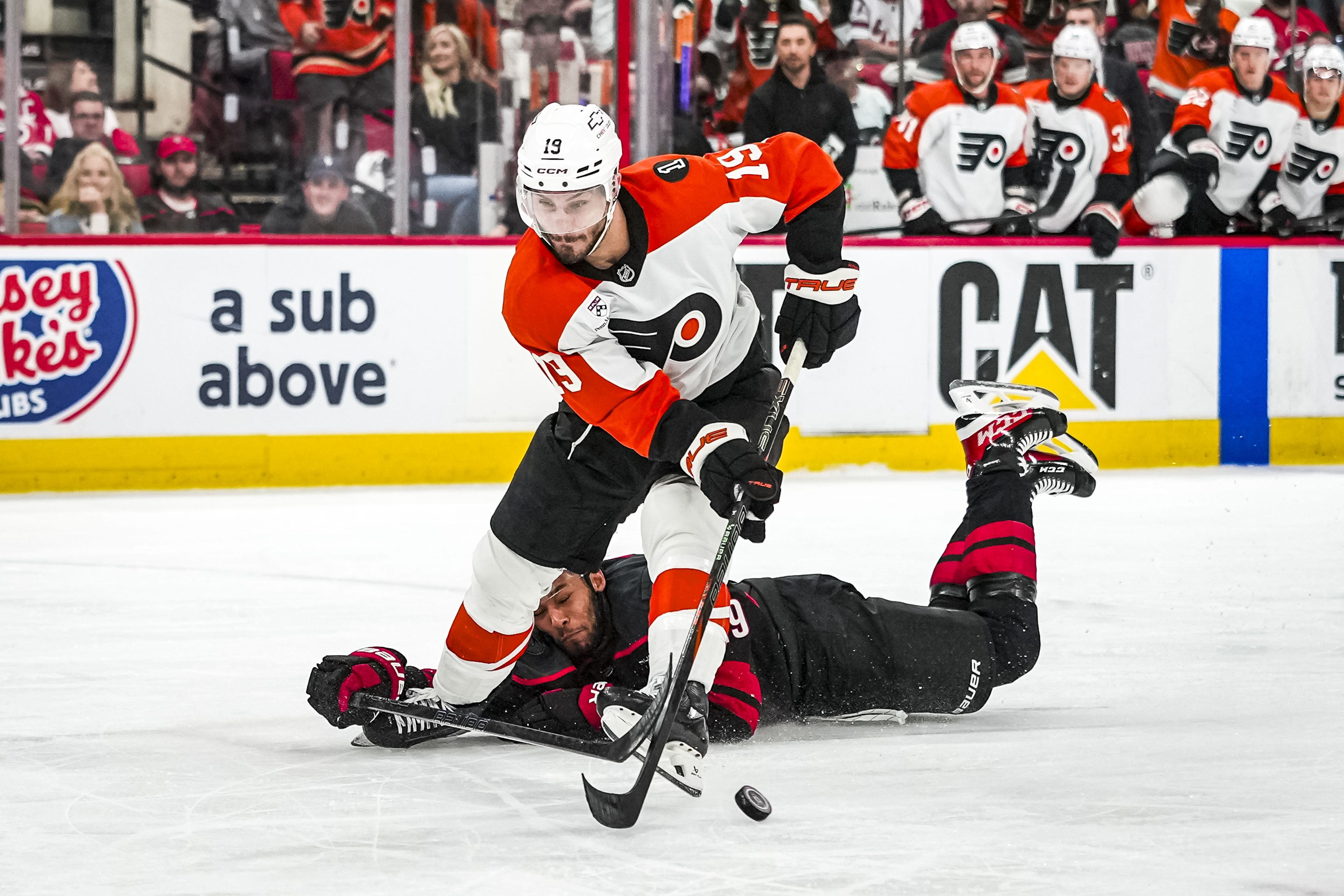 K'andre Miller #19 of the Carolina Hurricanes knocks the puck away from the Flyers' Garnet Hathaway in Game 1 of the teams' playoffs series.