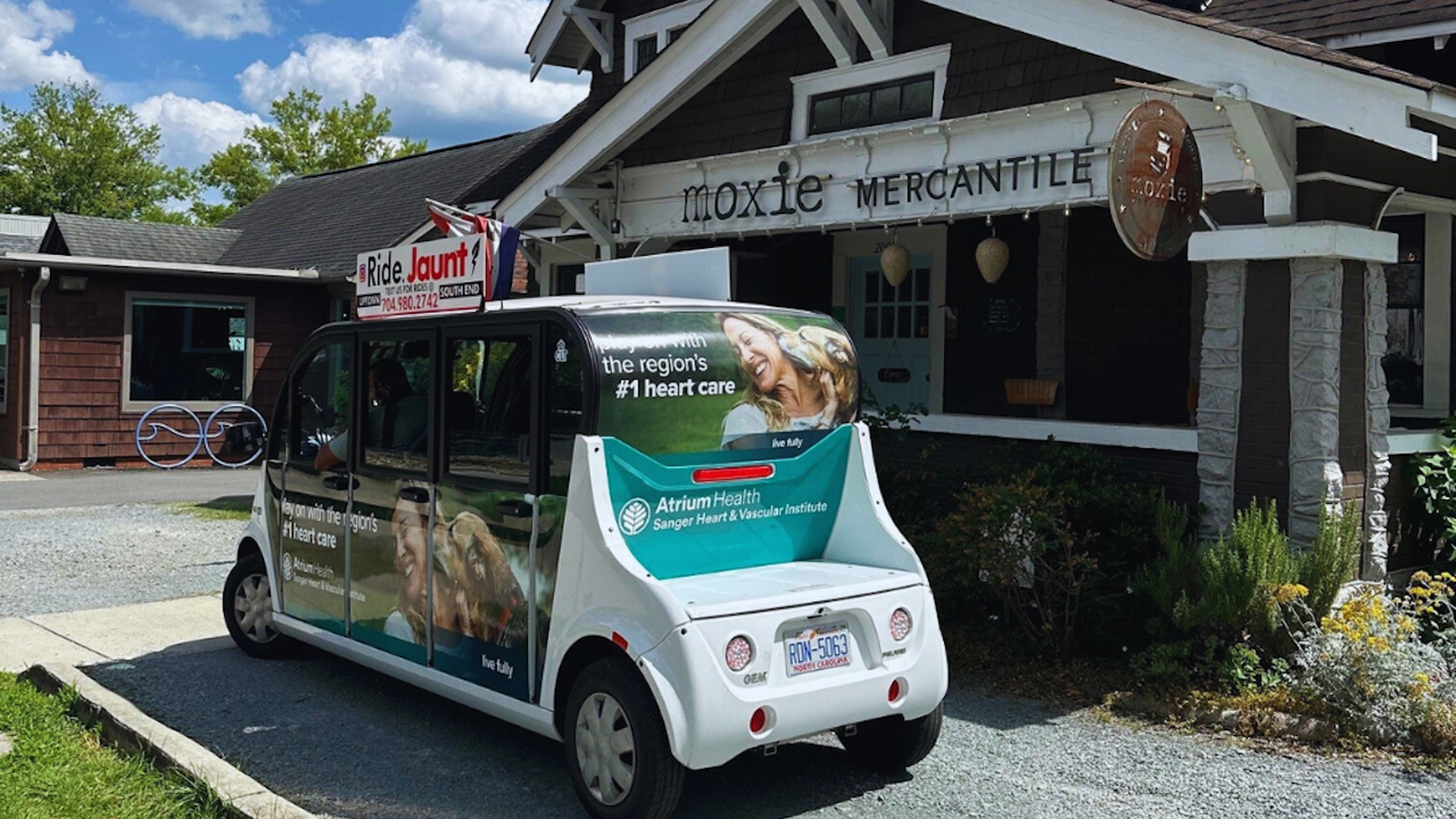 gold cart in front of moxie mercantile