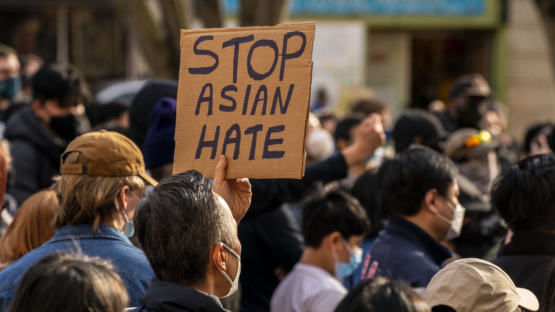 A man holds up a sign that says "Stop Asian Hate" at a rally and march in Seattle.