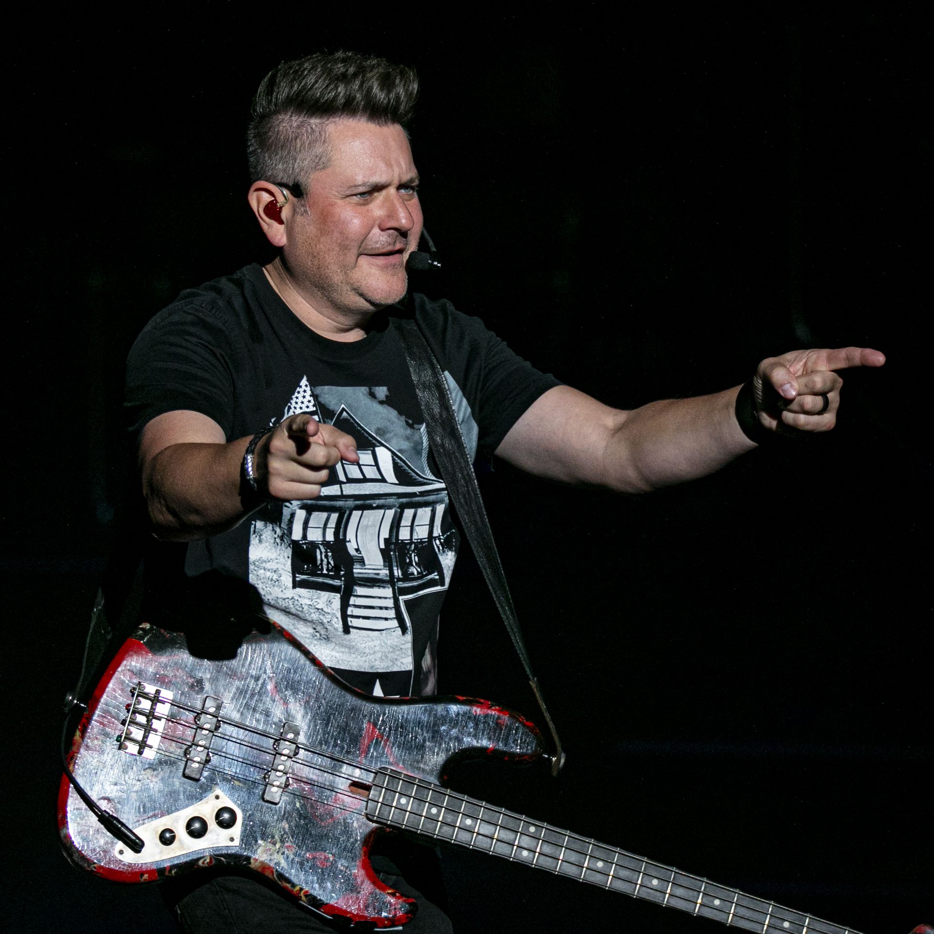 Jay DeMarcus points his fingers at a crowd
