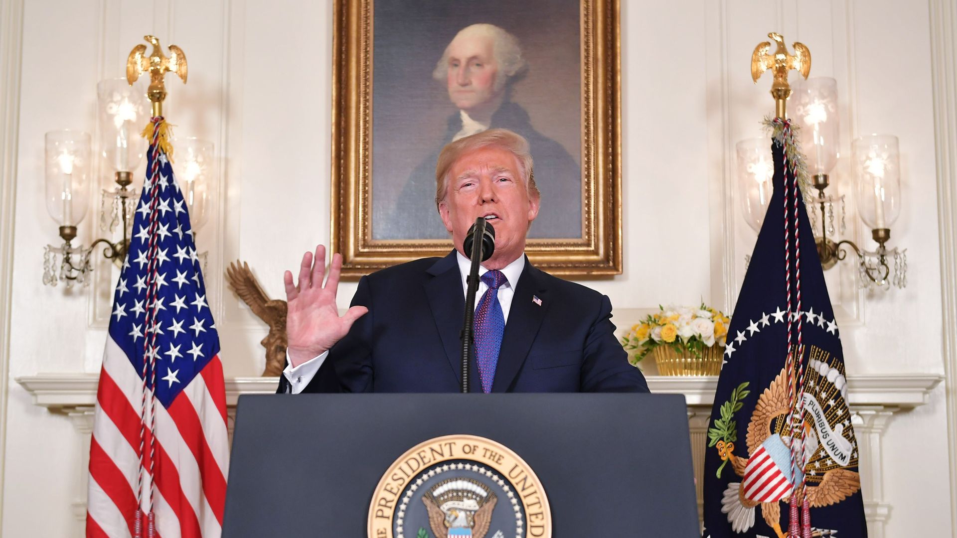 President Trump speaking at lectern in White House
