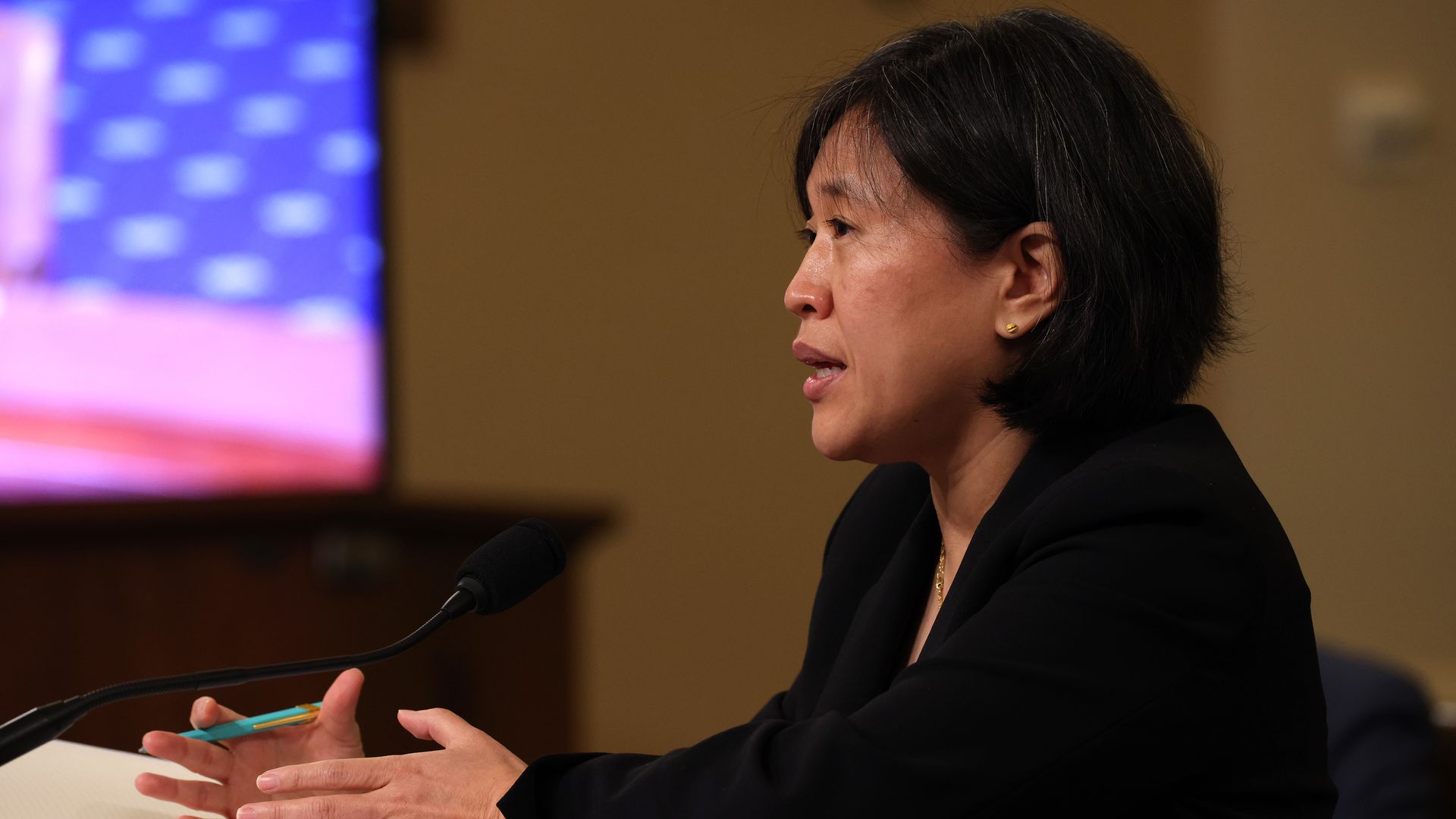 Katherine Tai sits and speaks while gesturing with her hands
