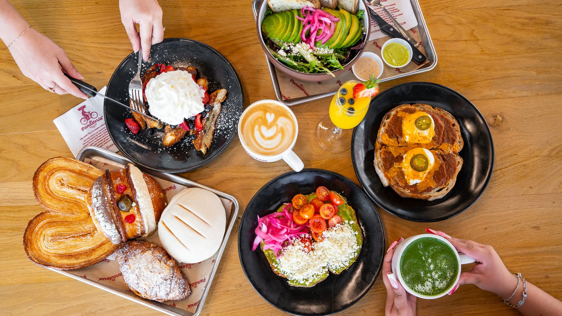 A spread of brunch items on a wooden table.