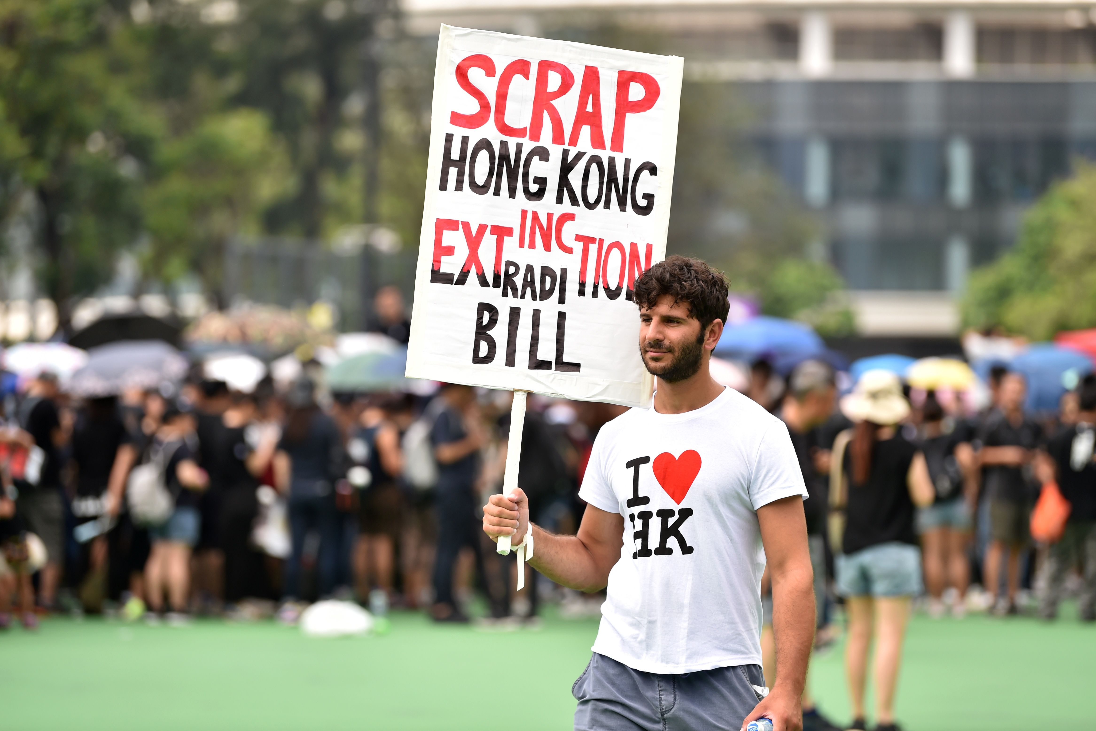 A protester holds up a placard as people gather ahead of a new rally.