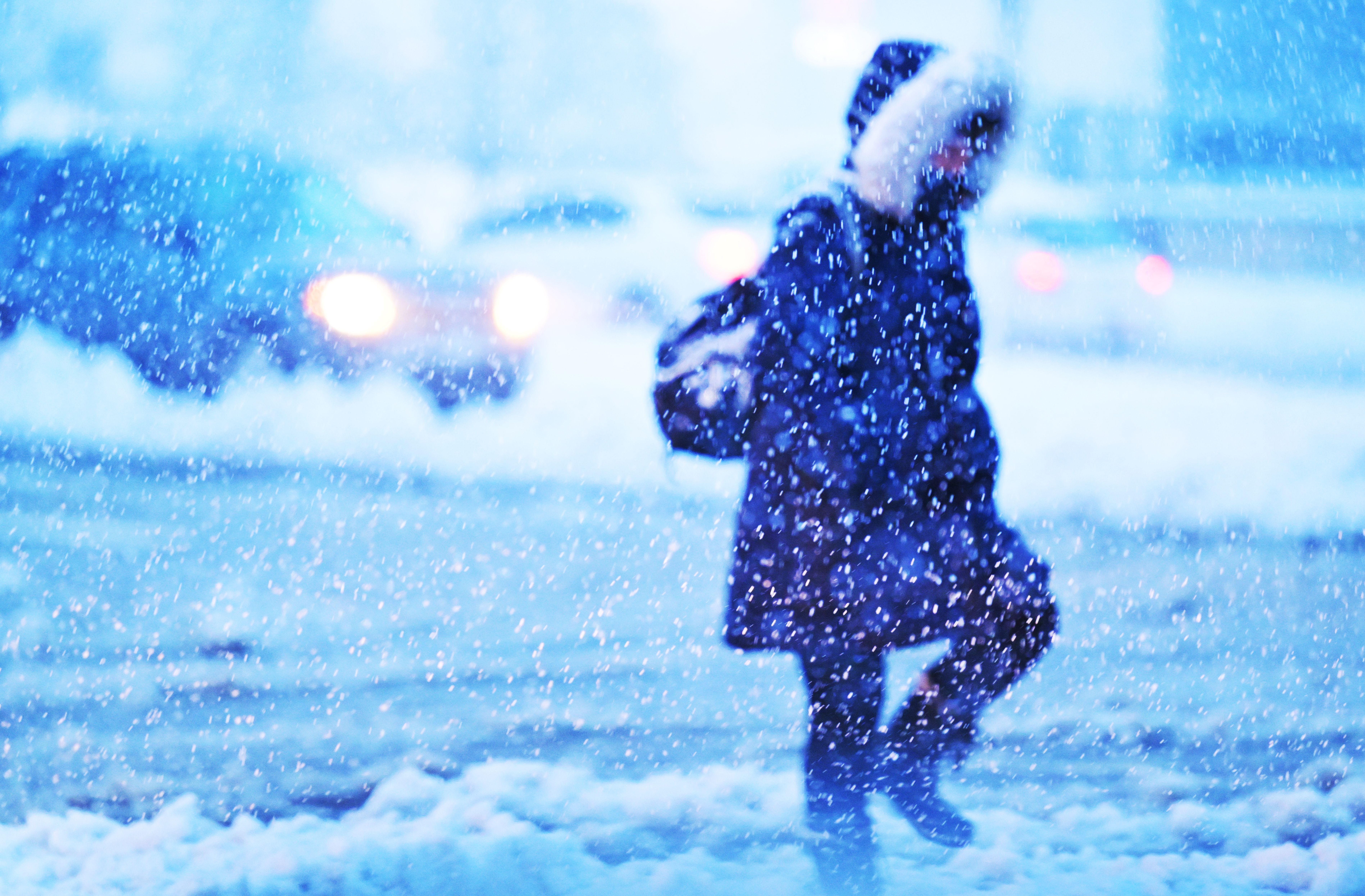 A pedestrian makes her way across West Colfax Avenue amid the snow. Photo: RJ Sangosti/Denver Post via Getty Images