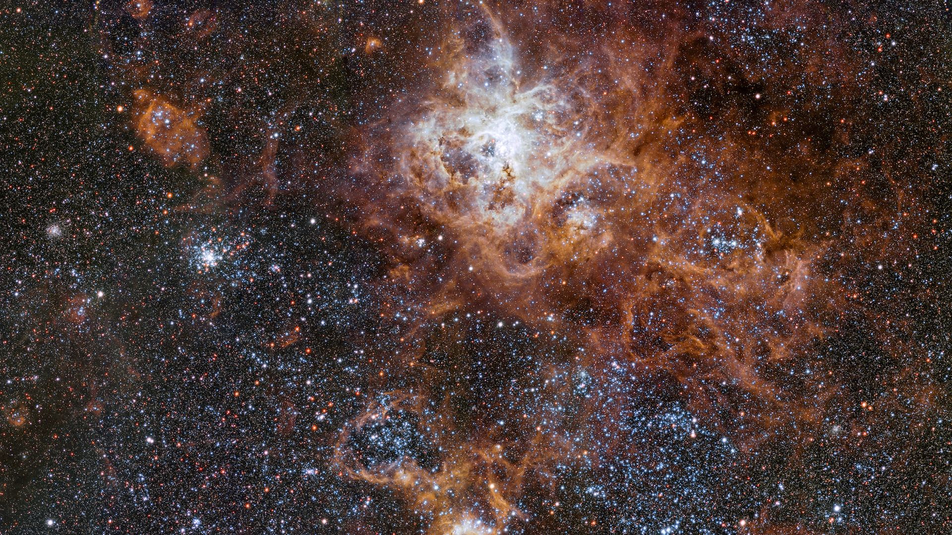 The Tarantula Nebula is about 160,000 light-years away from Earth, and contains extraordinarily bright star clusters and remnants of supernova explosions.