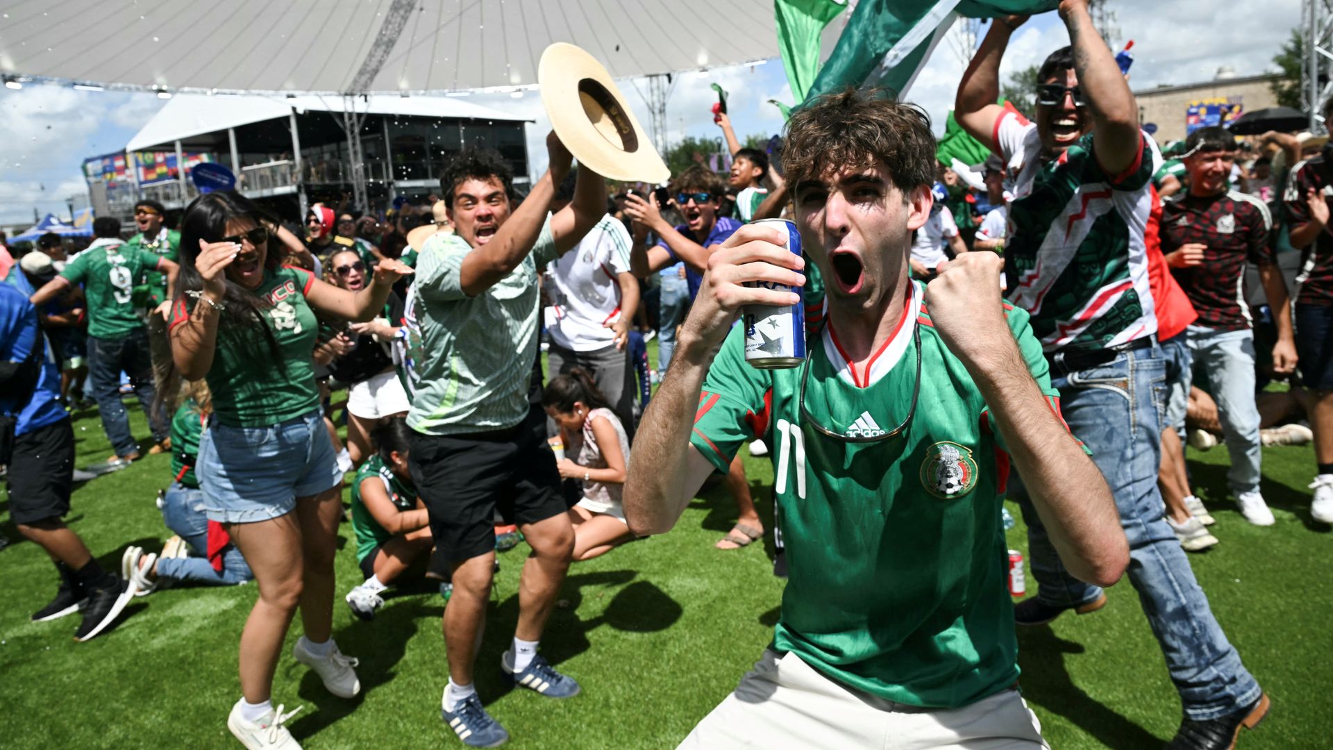 Fans of Mexico's soccer team celebrate a goal at Houston's FIFA Fan Festival watch party