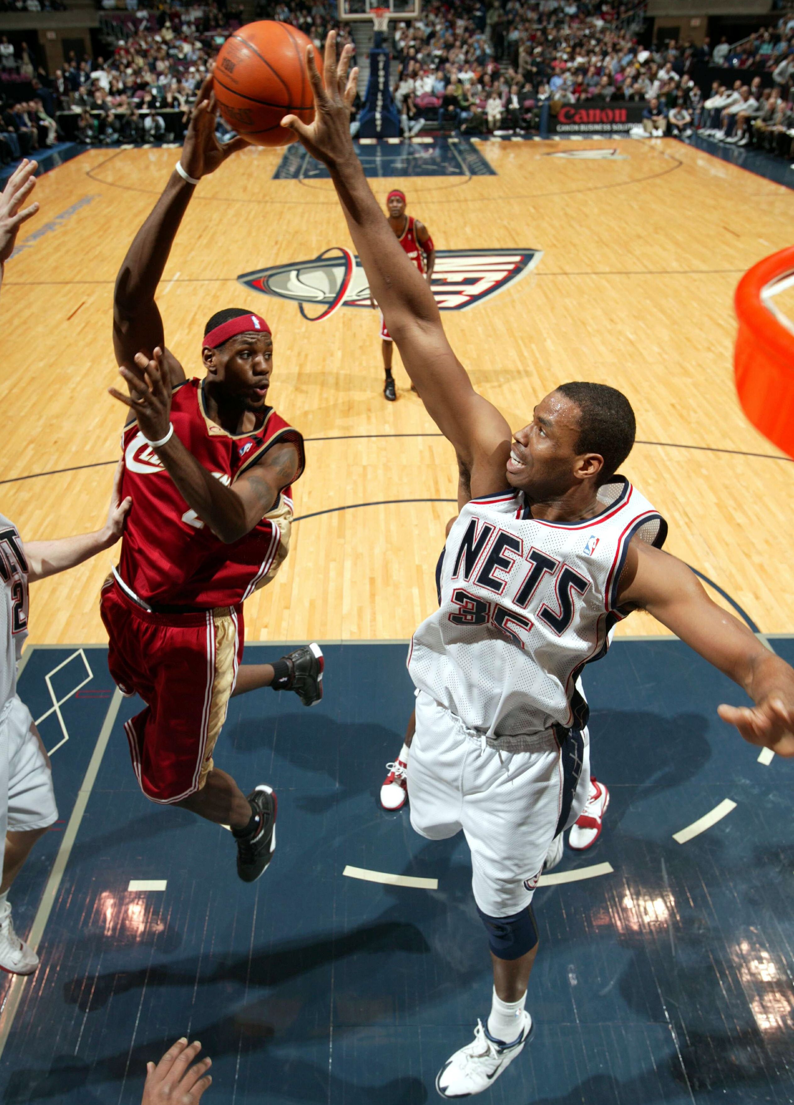 Jason Collins (right) blocks a shot from LeBron James — then in his second year in the NBA — in December 2004. 