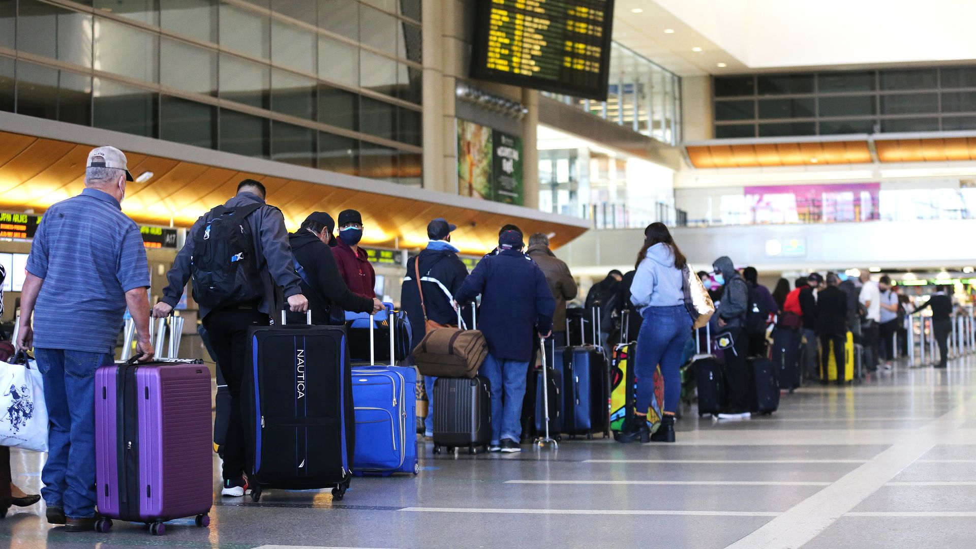 Travelers waiting in line to check in for a flight at Los Angeles International Airport on Dec. 22.