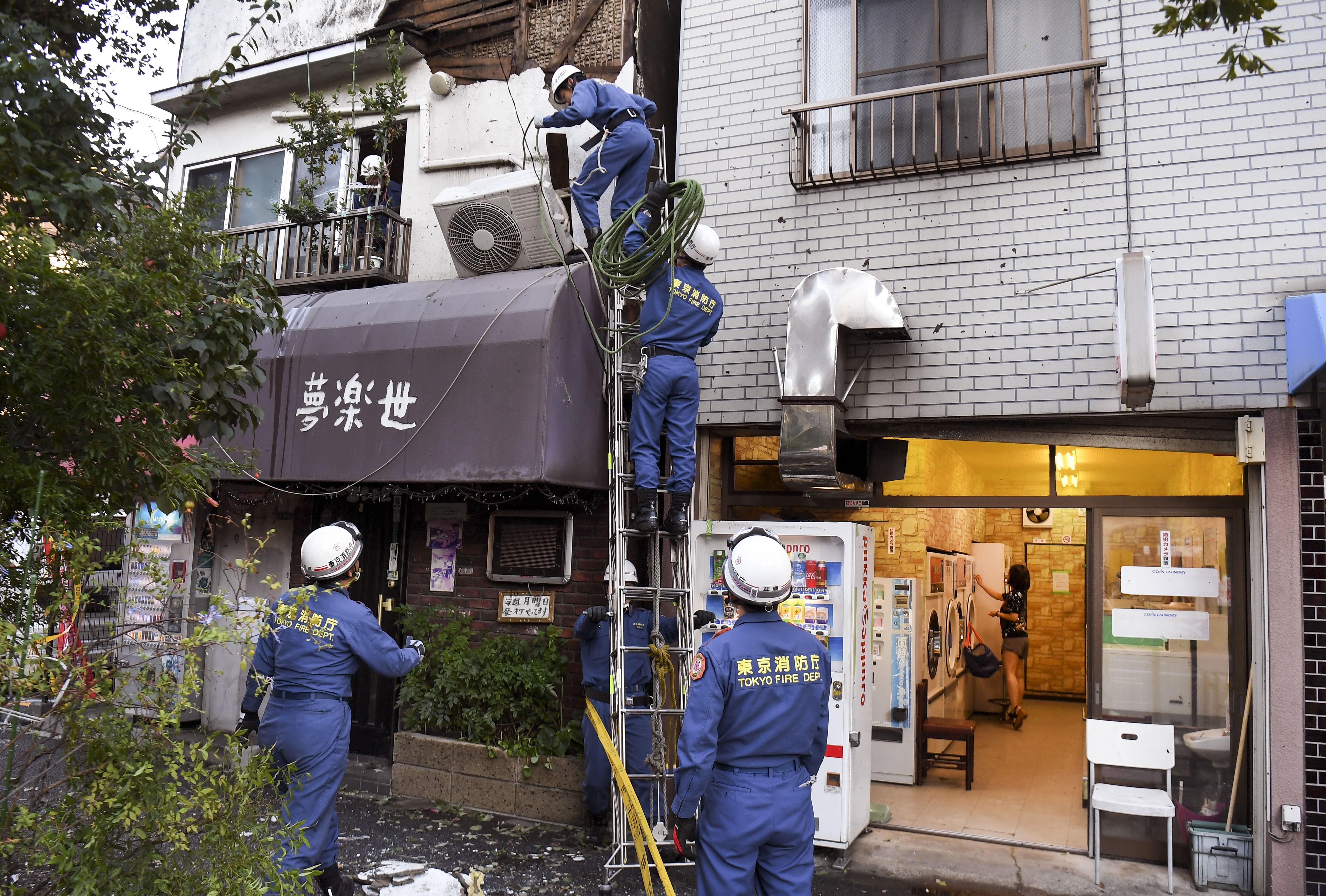  Tokyo Fire Department workers help repair damage in the aftermath of Typhoon Hagibis