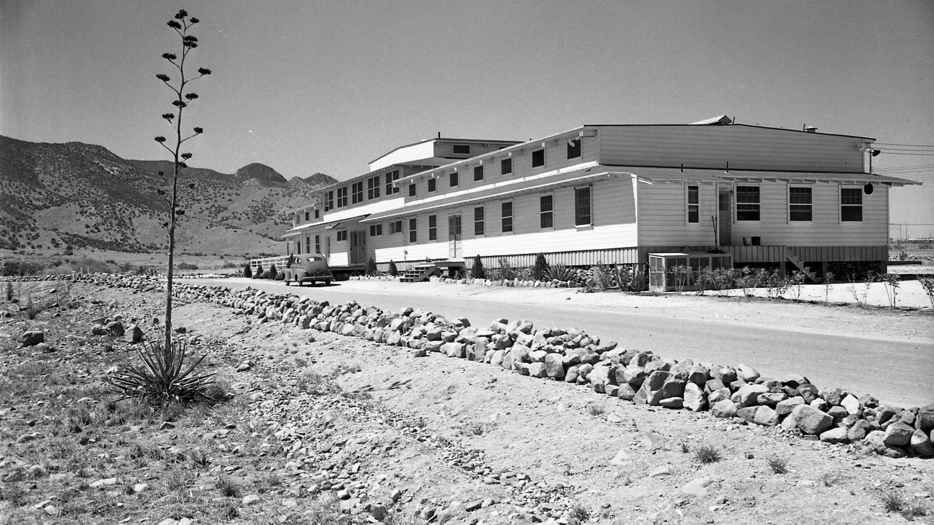 A long building in the middle of the desert. 