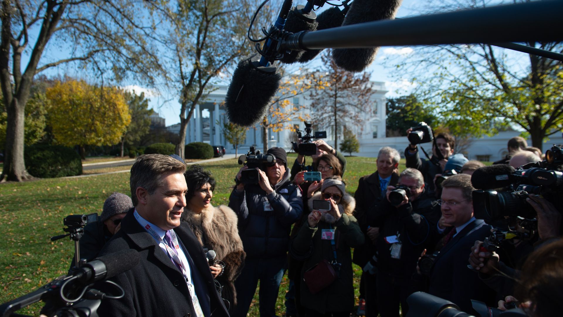 Jim Acosta stands before the press outside of the White House