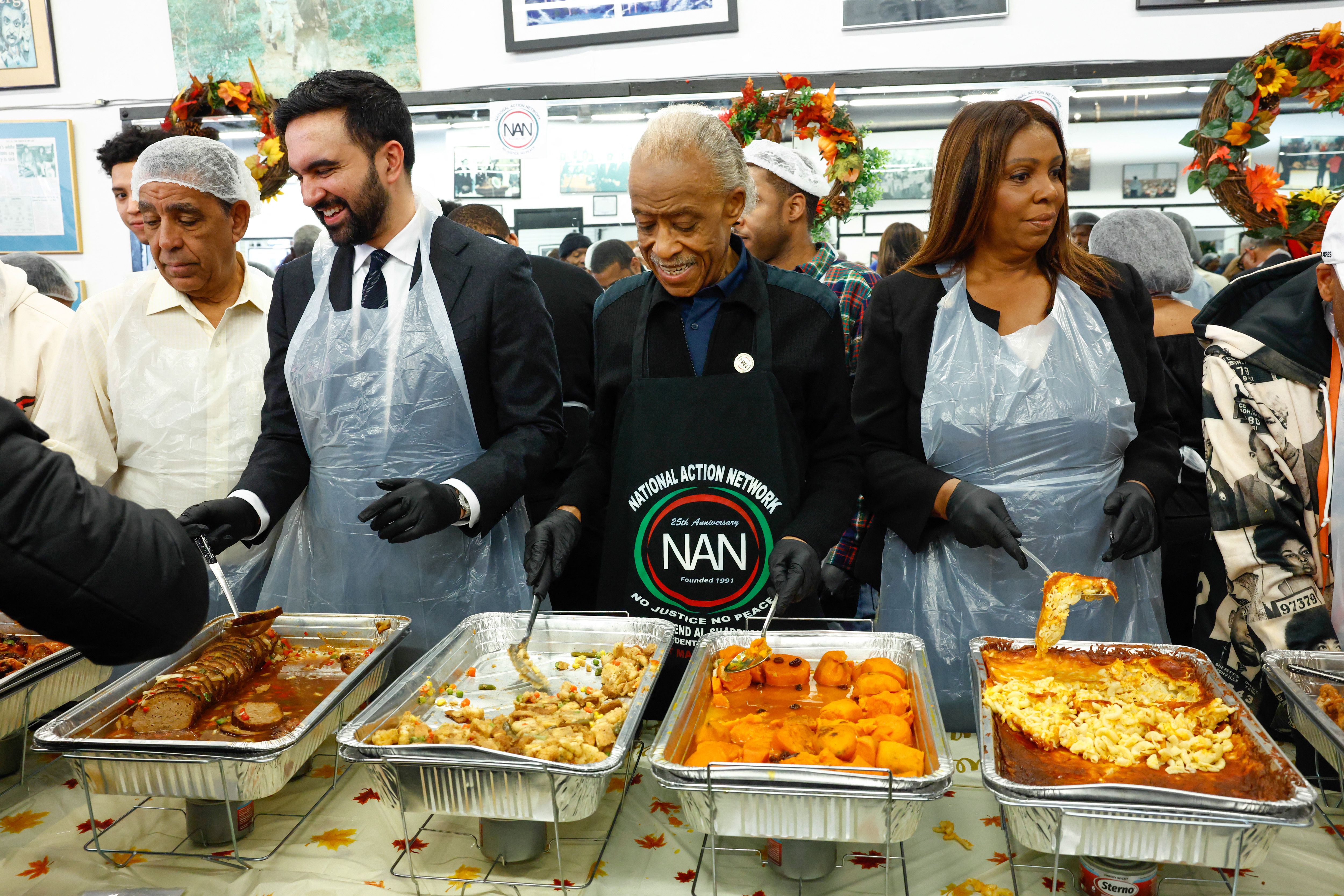 New York City mayor-elect Zohran Mamdani (2L), Reverend Al Sharpton (2R) and New York Attorney General Letitia James (R) serve meals at the National Action Network (NAN) Annual Thanksgiving Feeding event in Harlem, New York City, on Thanksgiving Day, November 27, 2025. (Photo by kena betancur / AFP