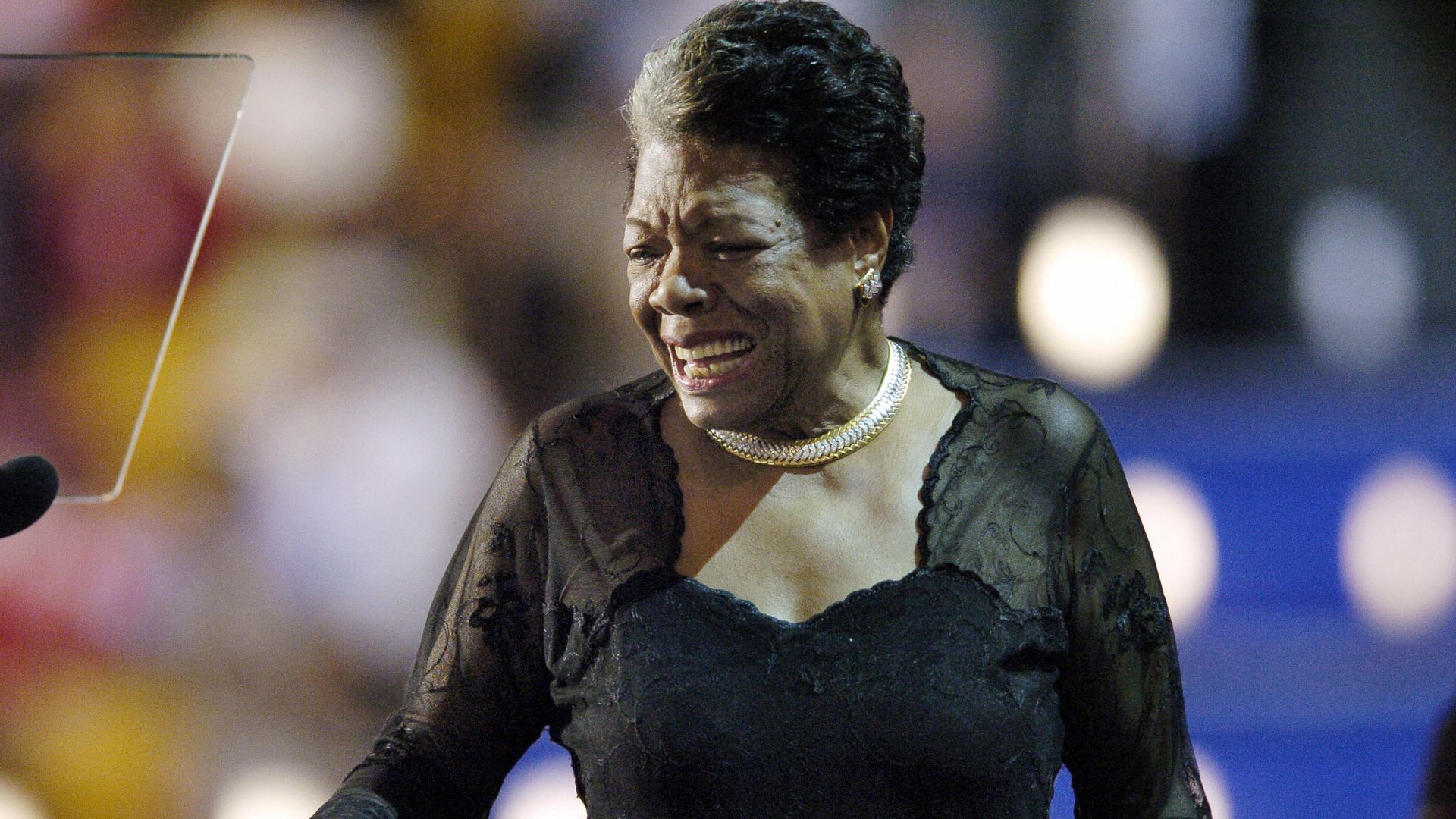 Photo of Maya Angelou wearing a black dress and smiling