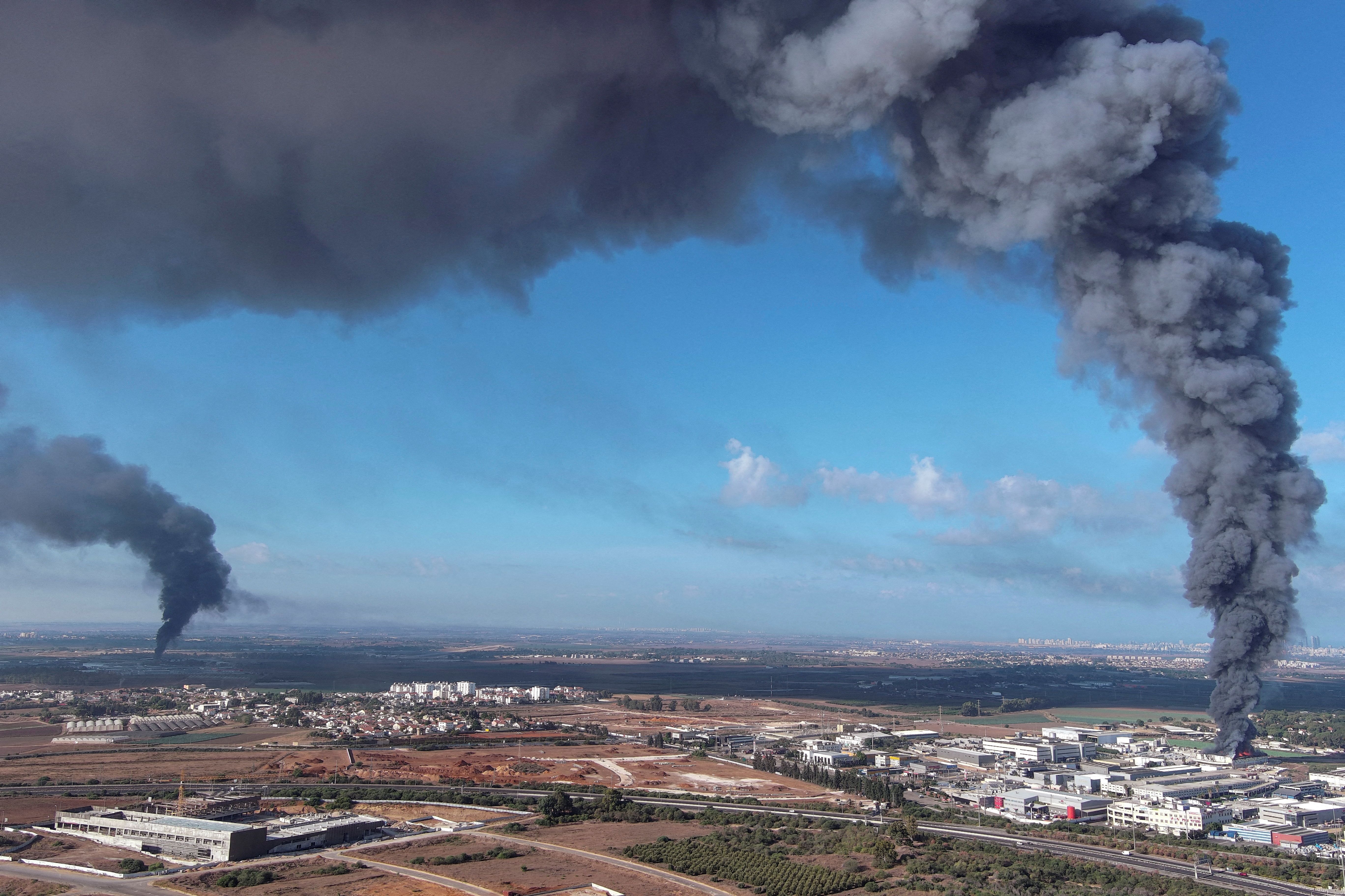 Smoke is seen in the Rehovot area of southern Israel as rockets are launched from the Gaza Strip on Oct. 7. Photo: Ilan Rosenberg/Reuters