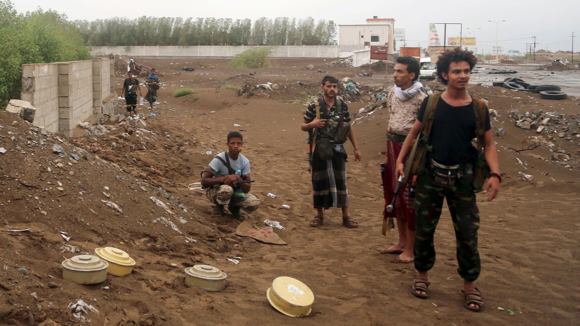 Houthi fighters standing near landmines