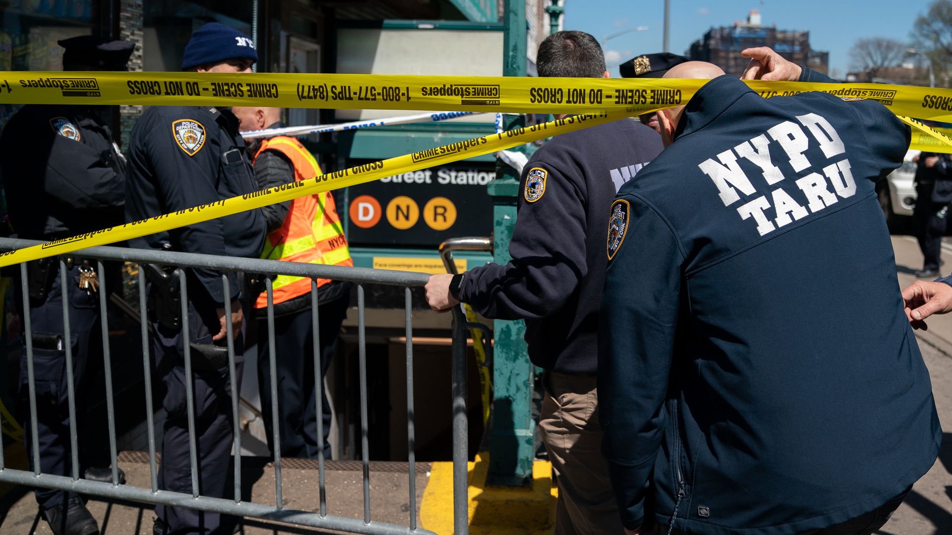 Members of the NYPD gather at the site of a shooting at the 36 St subway station in New York City.