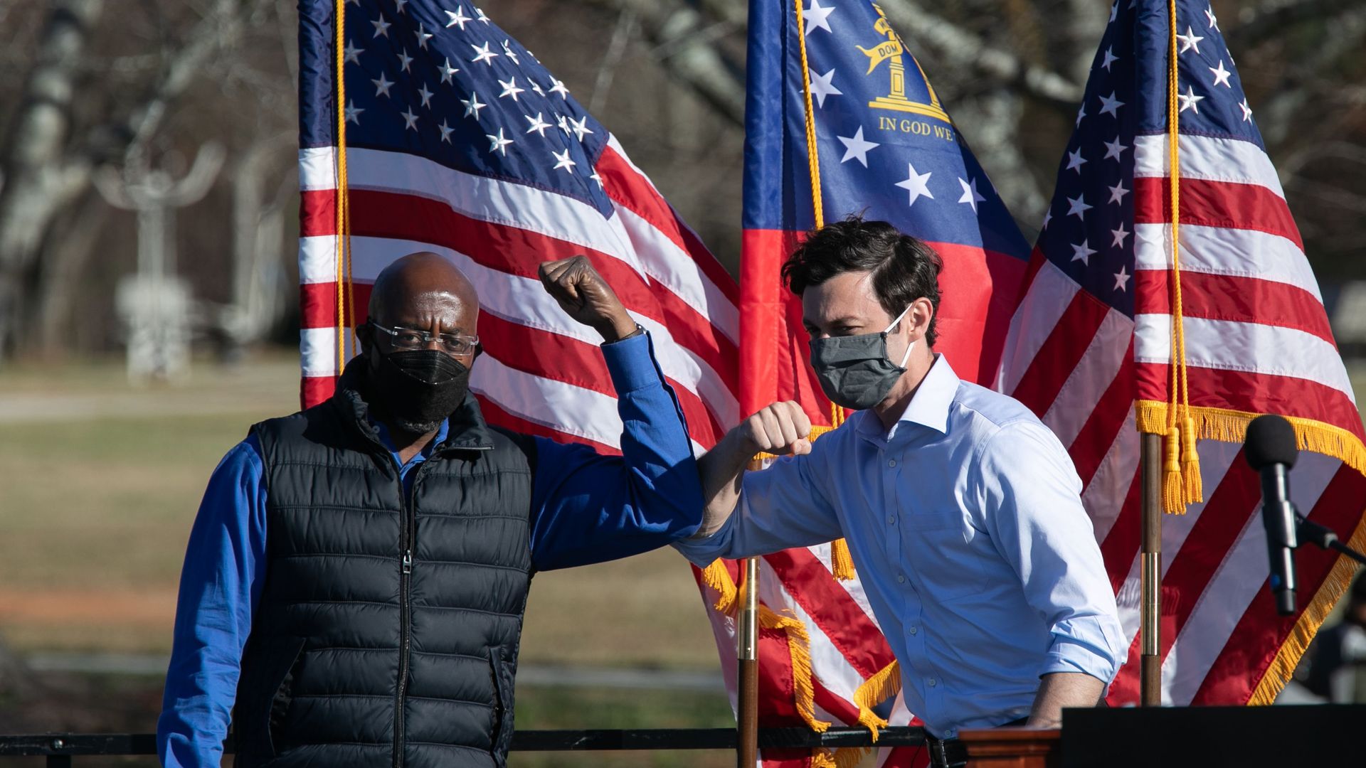 Democratic Senate candidates Raphael Warnock (left) and Jon Ossoff hold a drive-in rally yesterday in Conyers, Ga. Photo: Jessica McGowan/Getty Images
