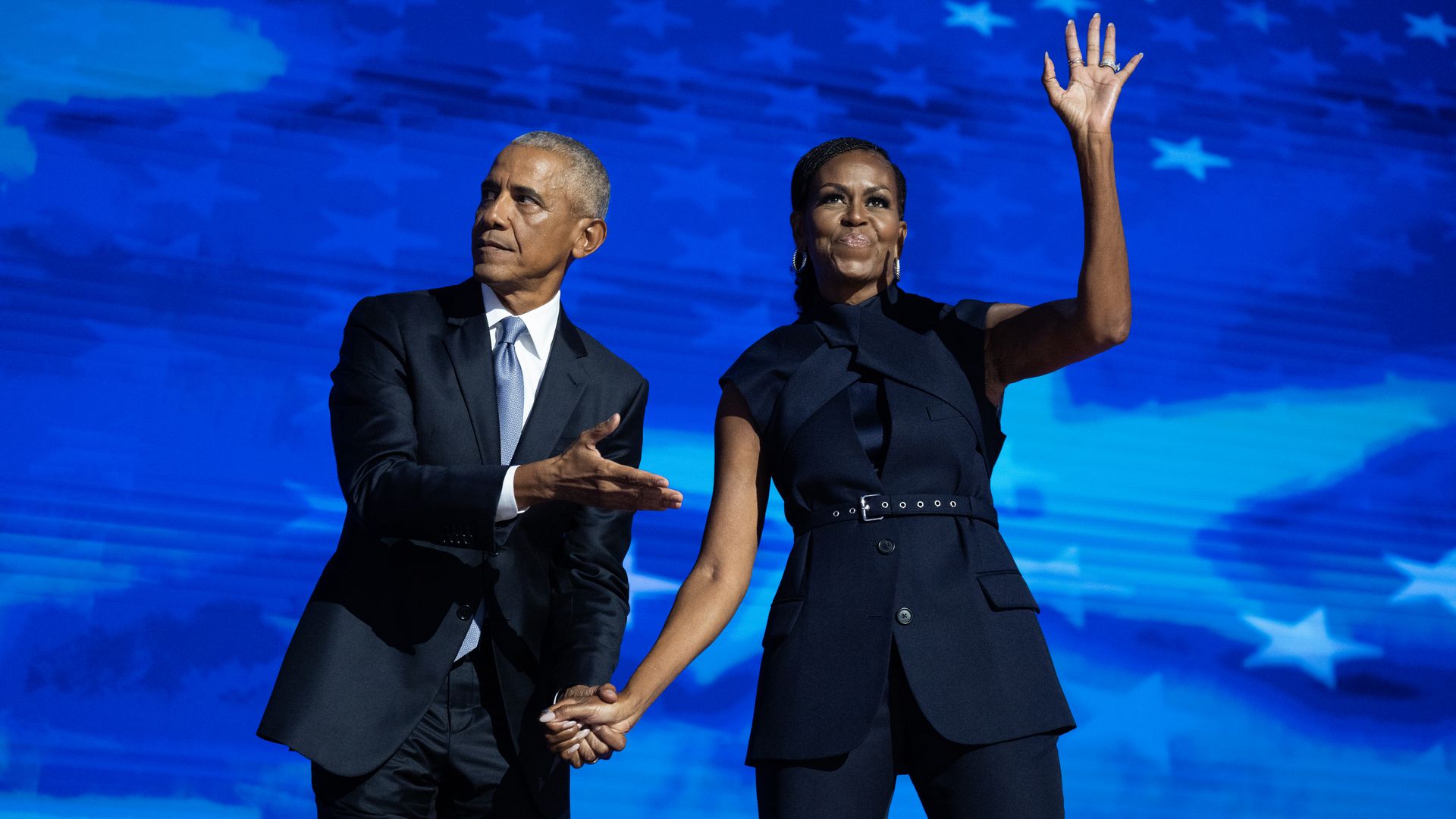Former President Barack Obama and former first lady Michelle Obama appear on stage in between their addresses on the second night of the Democratic National Convention at the United Center in Chicago, Ill., on Tuesday, August 20, 2024. 