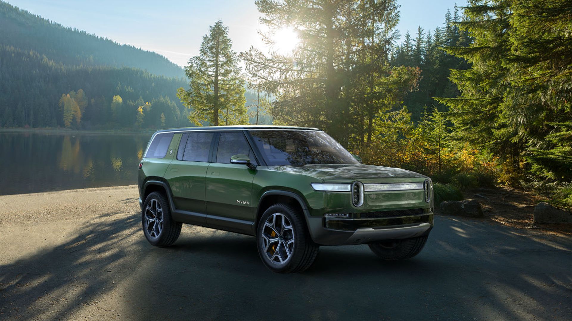 Image of battery-powered Rivian R1S SUV next to a lake