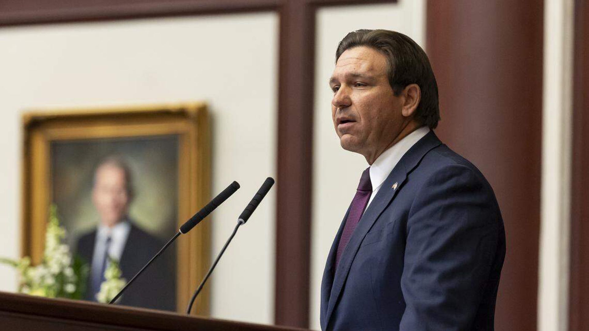Gov. Ron DeSantis speaking at a podium.