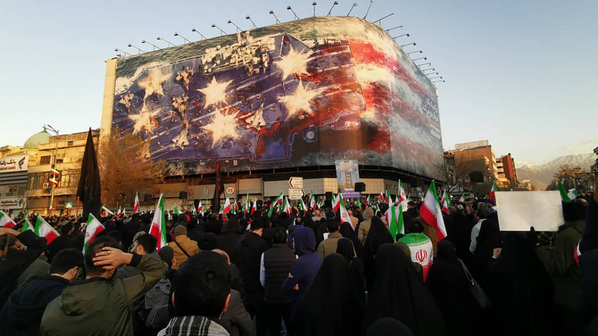 Crowd of mourners in Tehran streets holding pictures of Ayatollah Ali Khamenei and Iranian flags during mourning ceremonies after state media confirmed his death in U.S.-Israeli strikes.