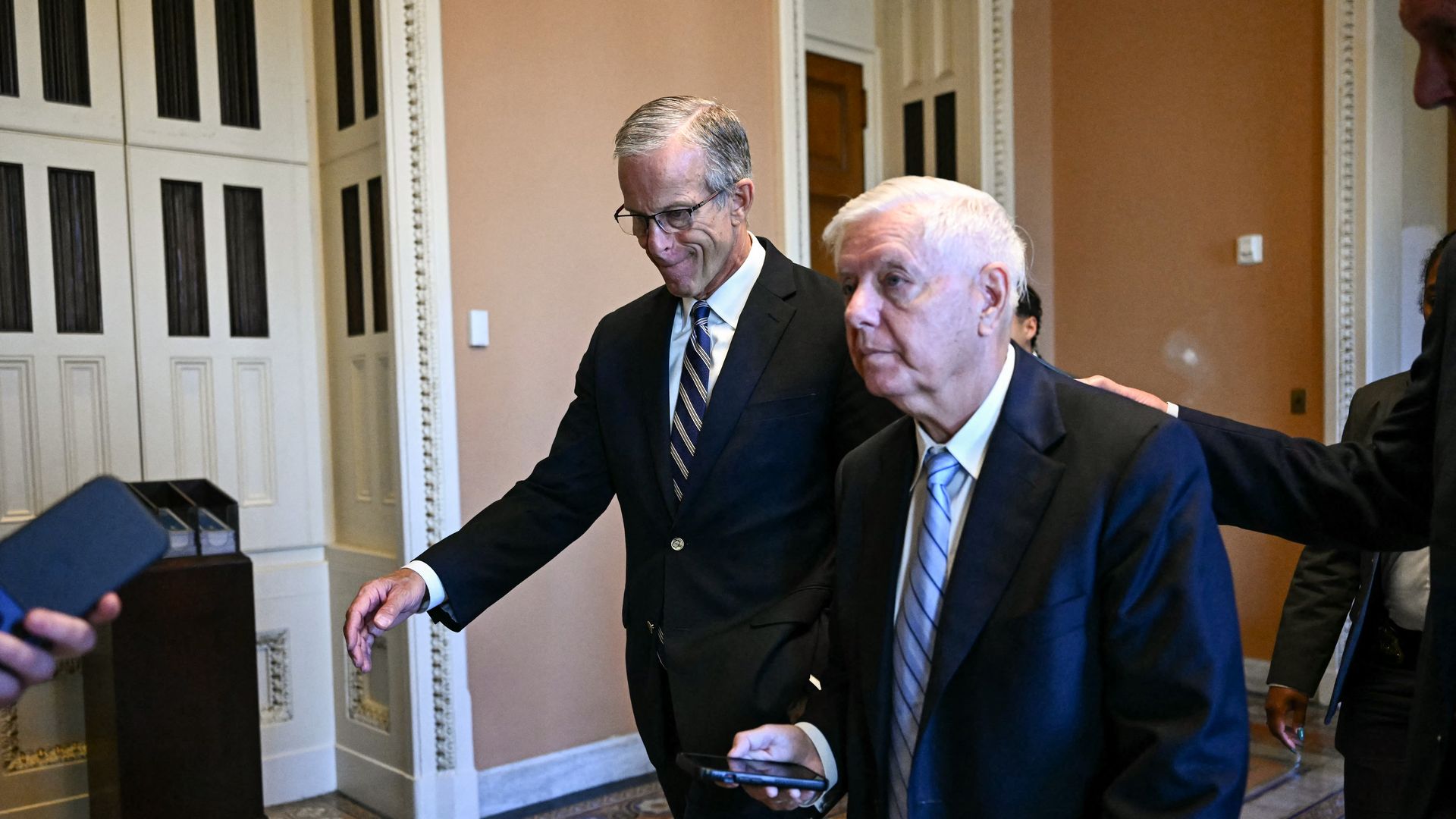 Senate Majority Leader John Thune, walks with Sen. Lindsey Graham at the U.S. Capitol on June 4.