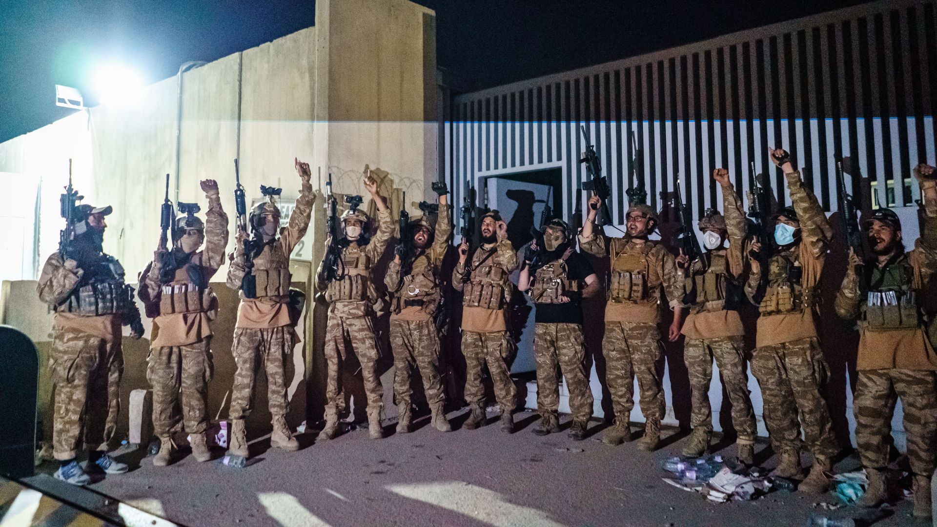  Taliban fighters from the Fateh Zwak unit celebrate before storming into the Kabul International Airport in Kabul, Afghanistan, Tuesday, Aug. 31