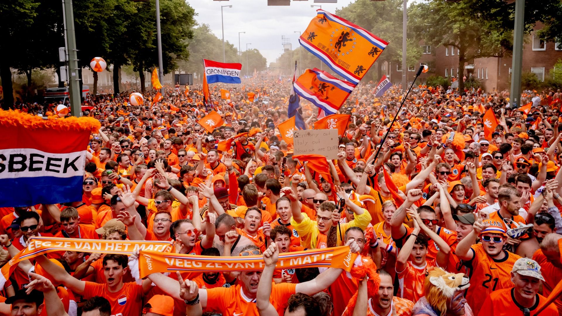 Thousands of Dutch fans clad in orange marching in the streets of Berlin for the UEFA Euro 2024 quarter-final waving flags, shouting, holding their hands in the air and throwing beach balls. 